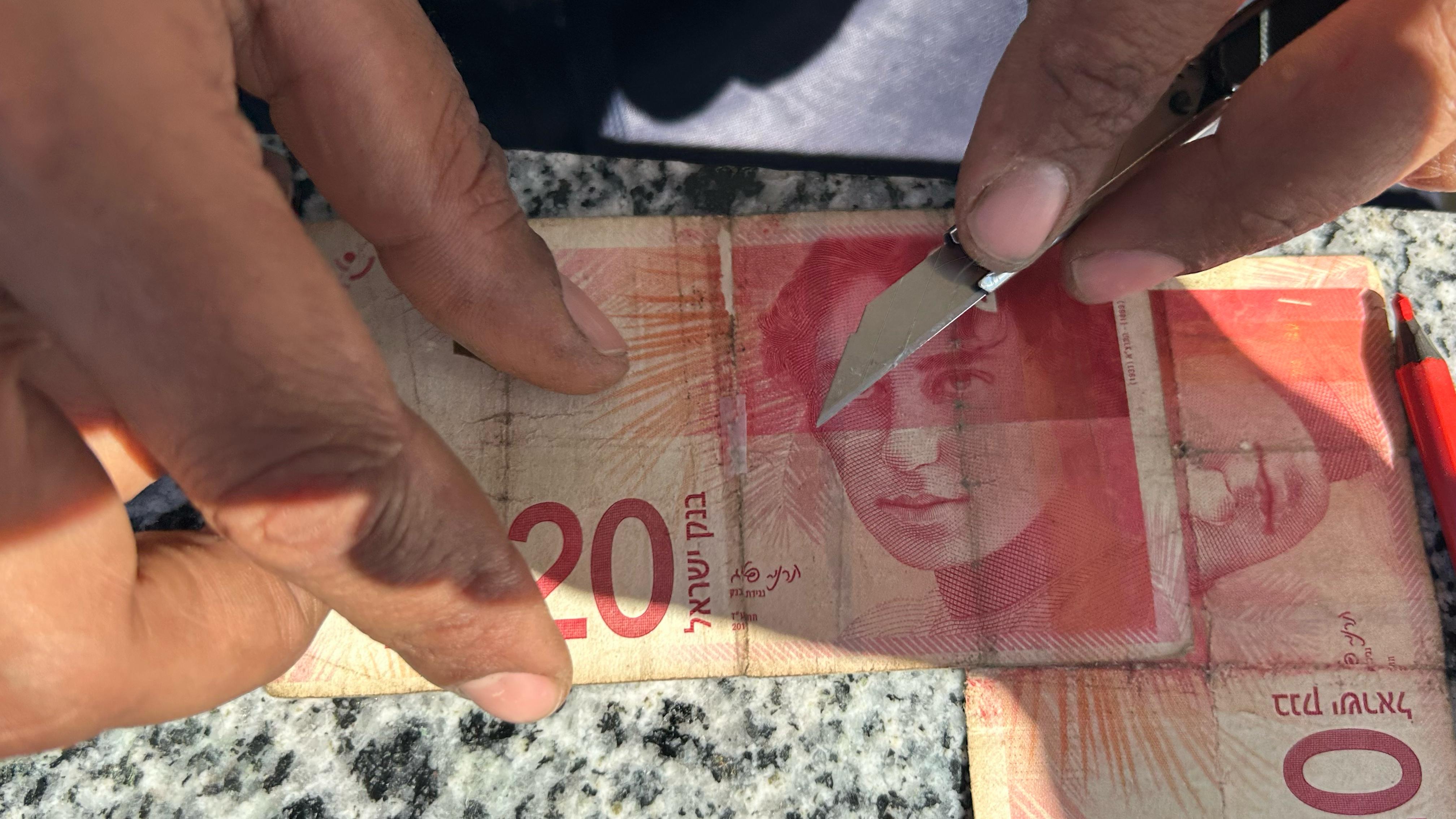 A detail of the repair process on a banknote in Khan Younis, April 15.