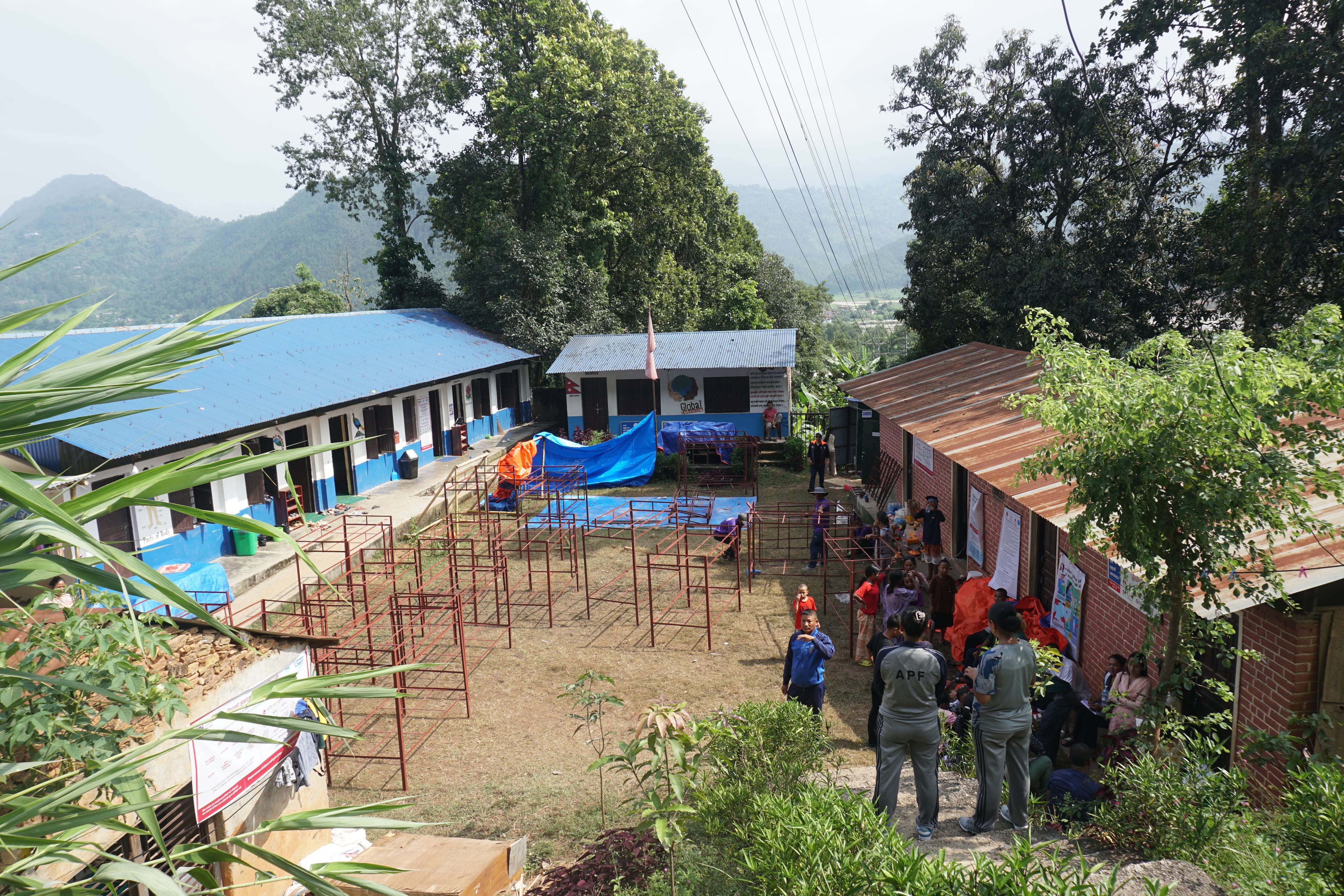Students and authorities gather at a school that serves as a shelter for children orphaned after the flood in Nuwakot, Nepal, on September 19, 2026. 