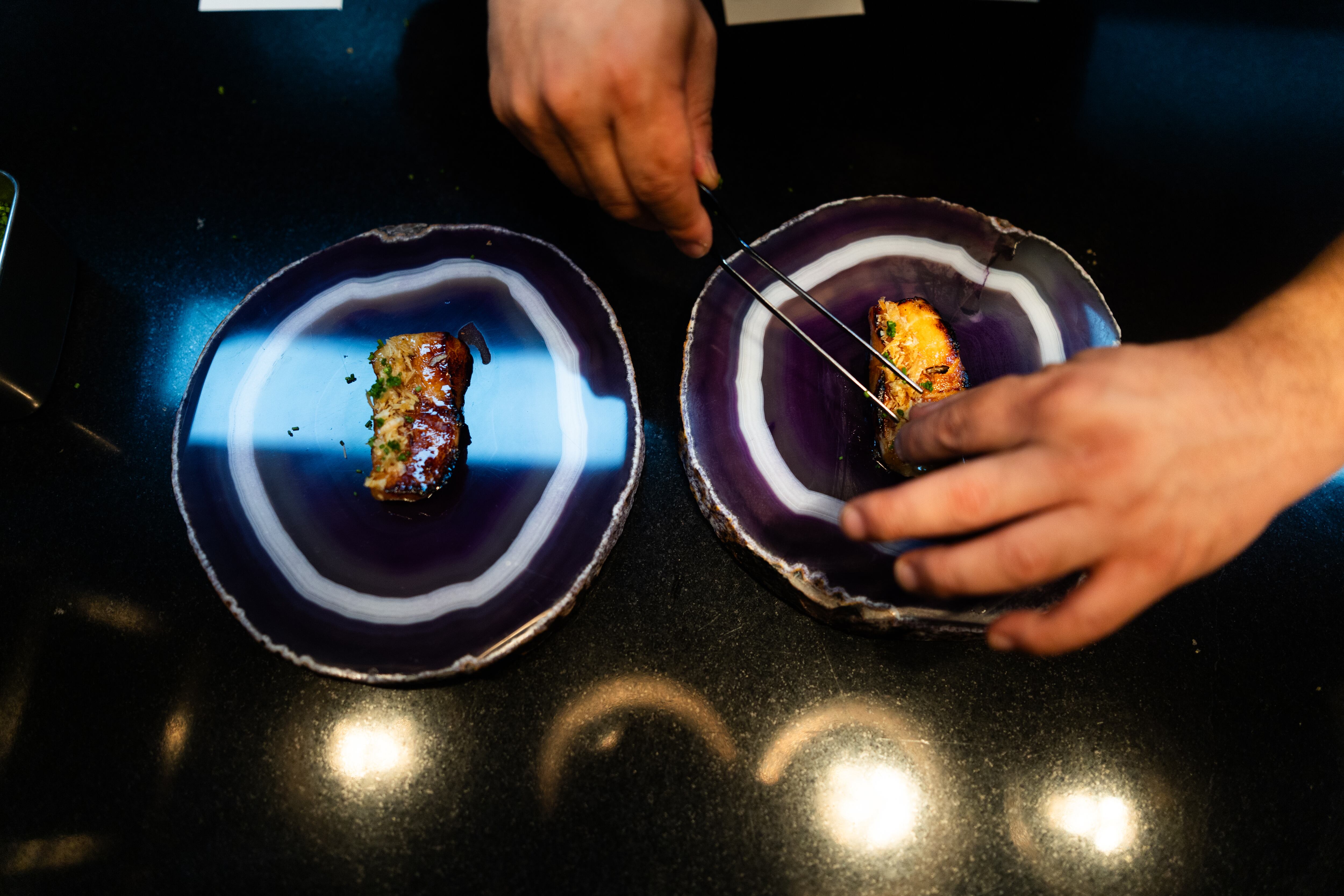 A cook puts the finishing touches on a dish at Maido restaurant in Lima, Peru.