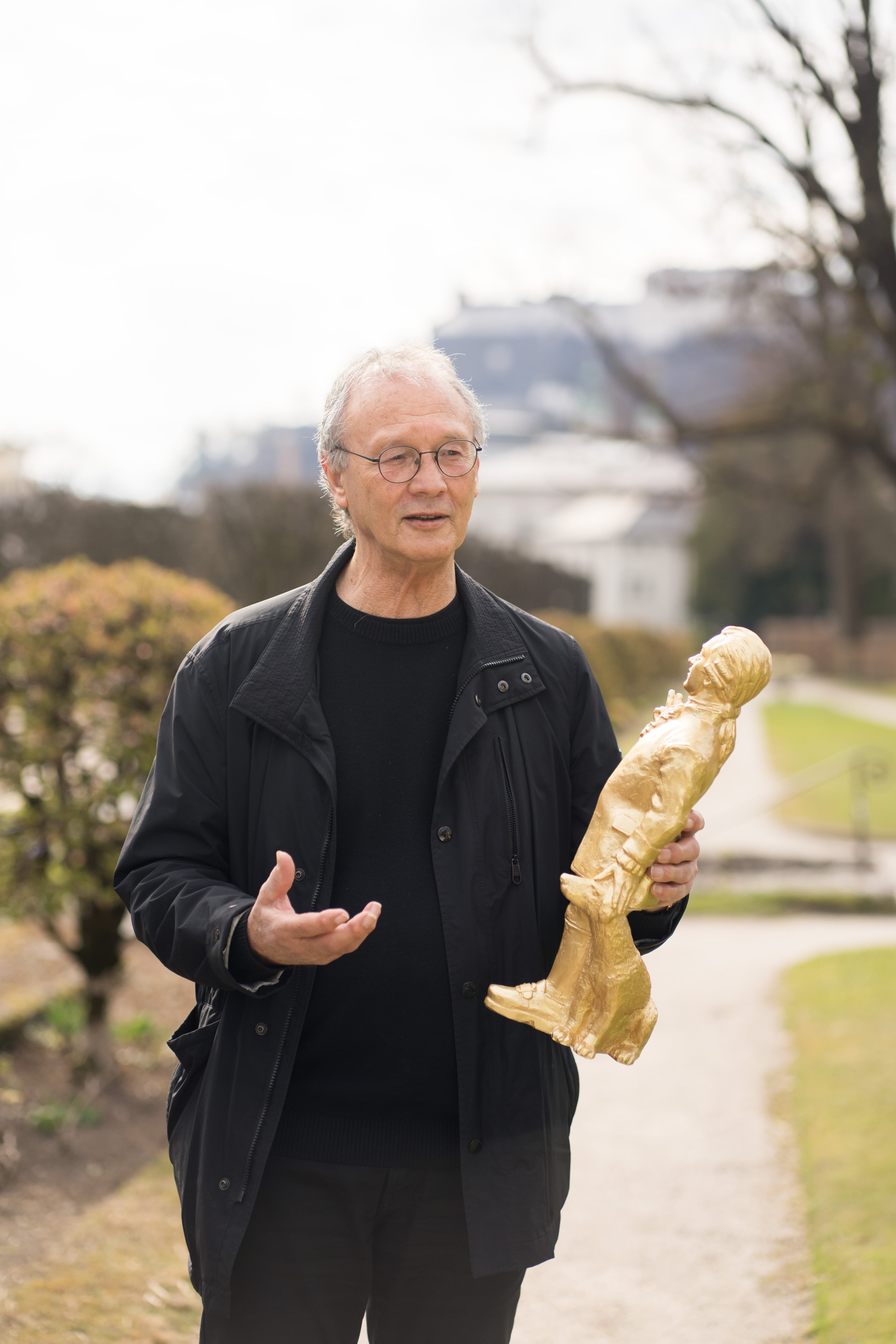 German artist Ottmar Hörl holds one of the Mozart statuettes in the gardens of Mirabell Palace (Salzburg), in a photo provided by the artist himself.