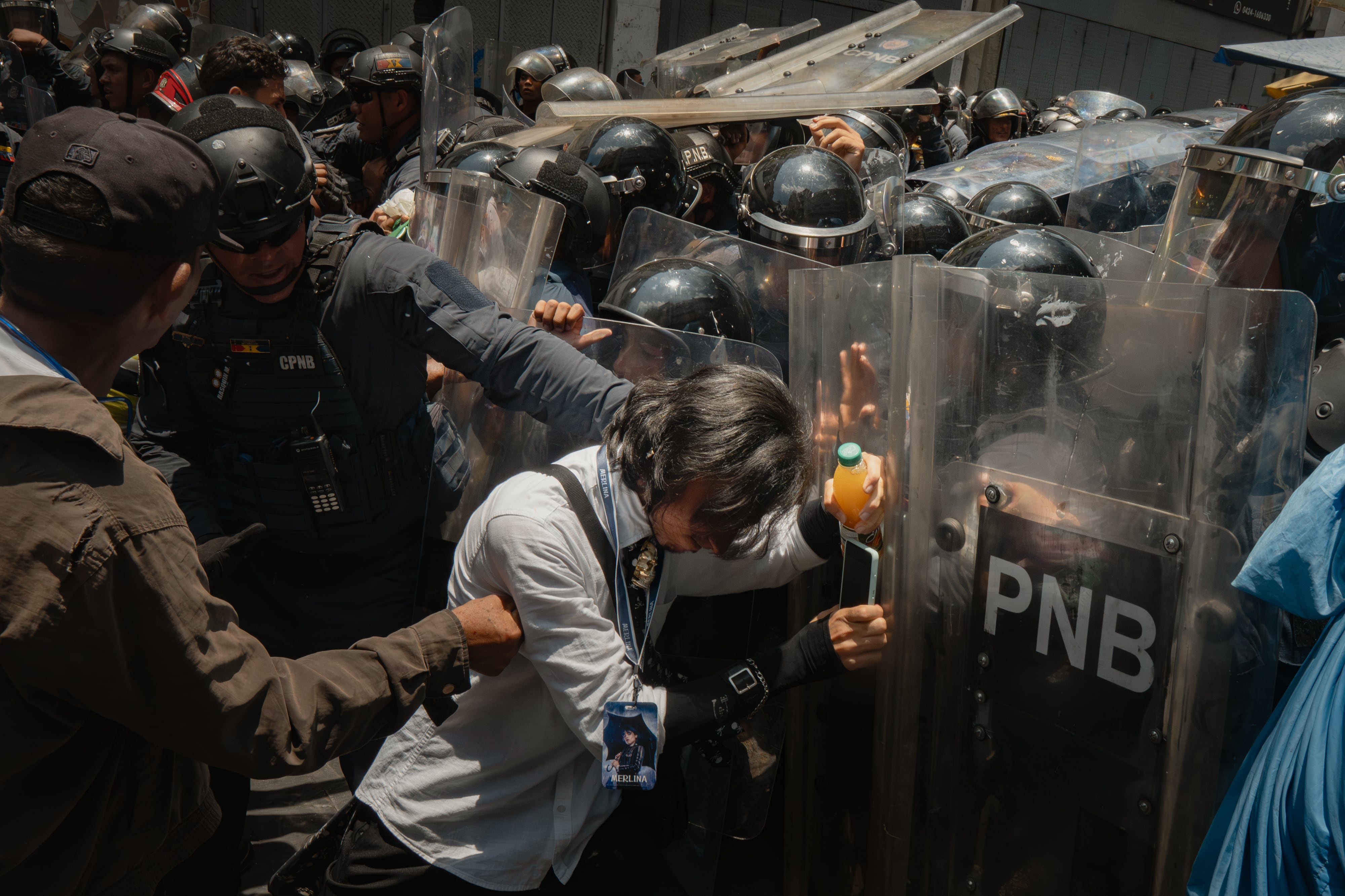 Workers and retirees clash with the Bolivarian National Police in downtown Caracas.