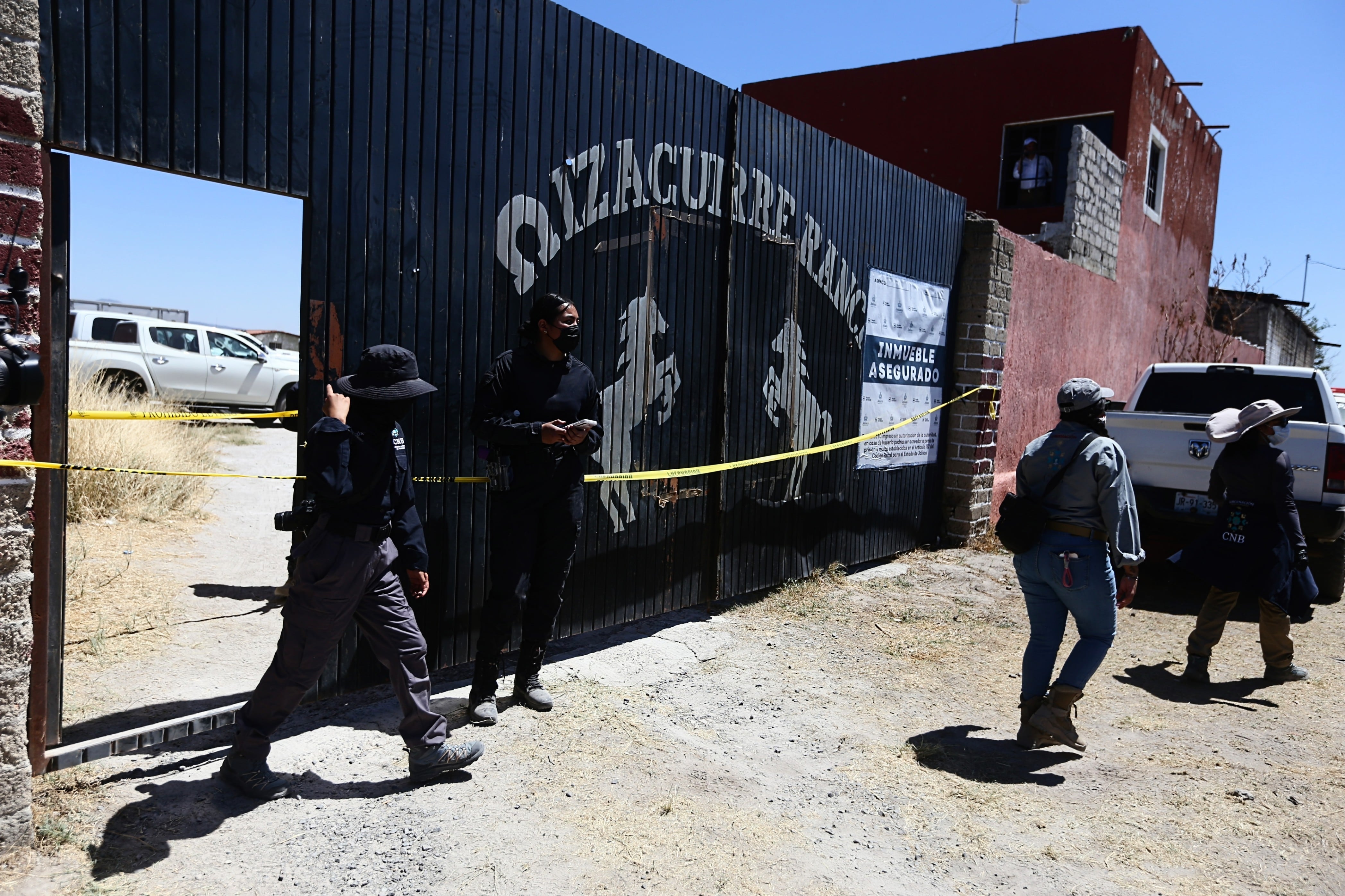 Police guard the entrance to the ranch in Teuchitlán, on March 13.