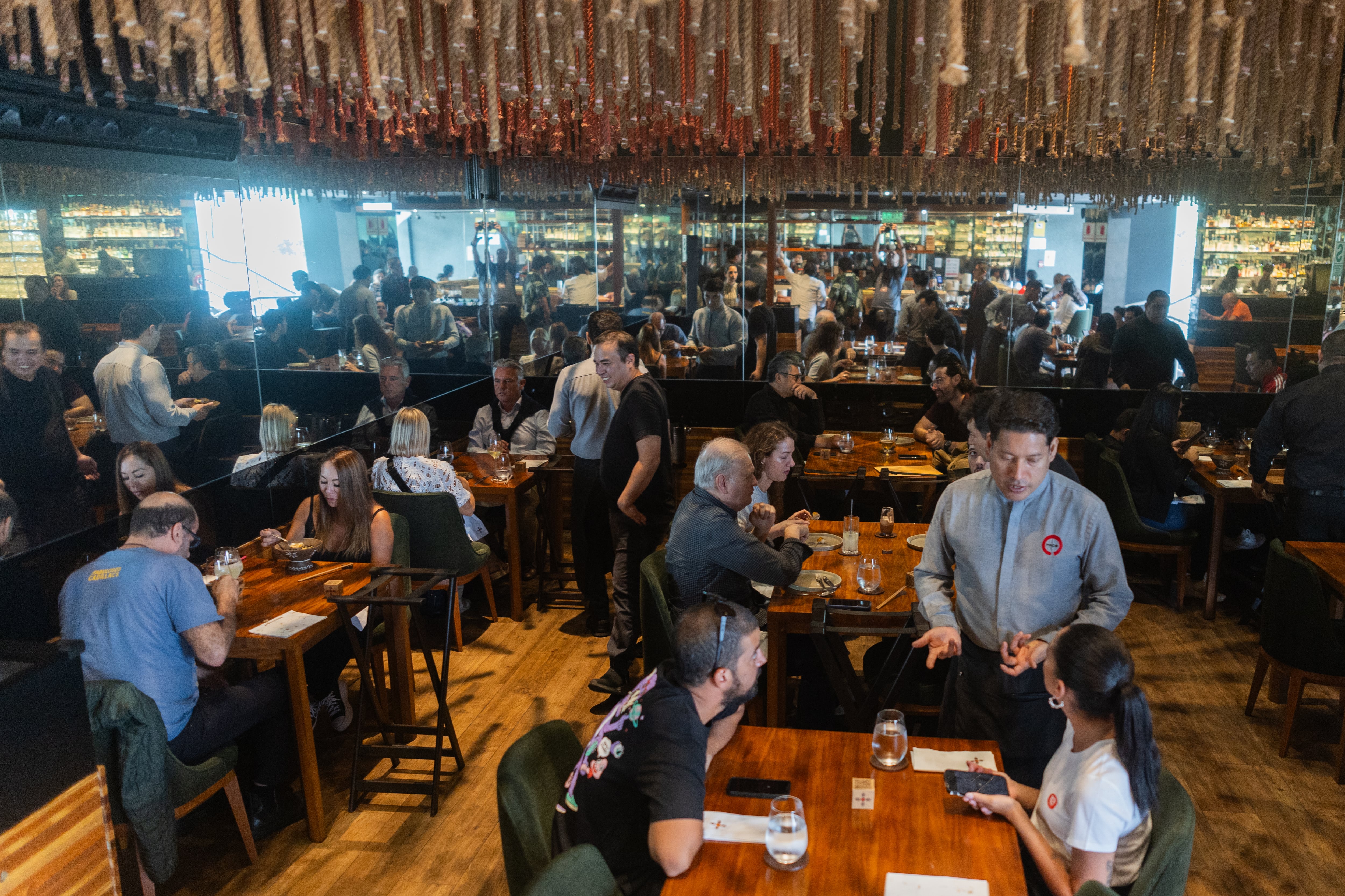 Diners at Maido restaurant sit under a ceiling decoration made from 1,000 ropes from fishing boats.