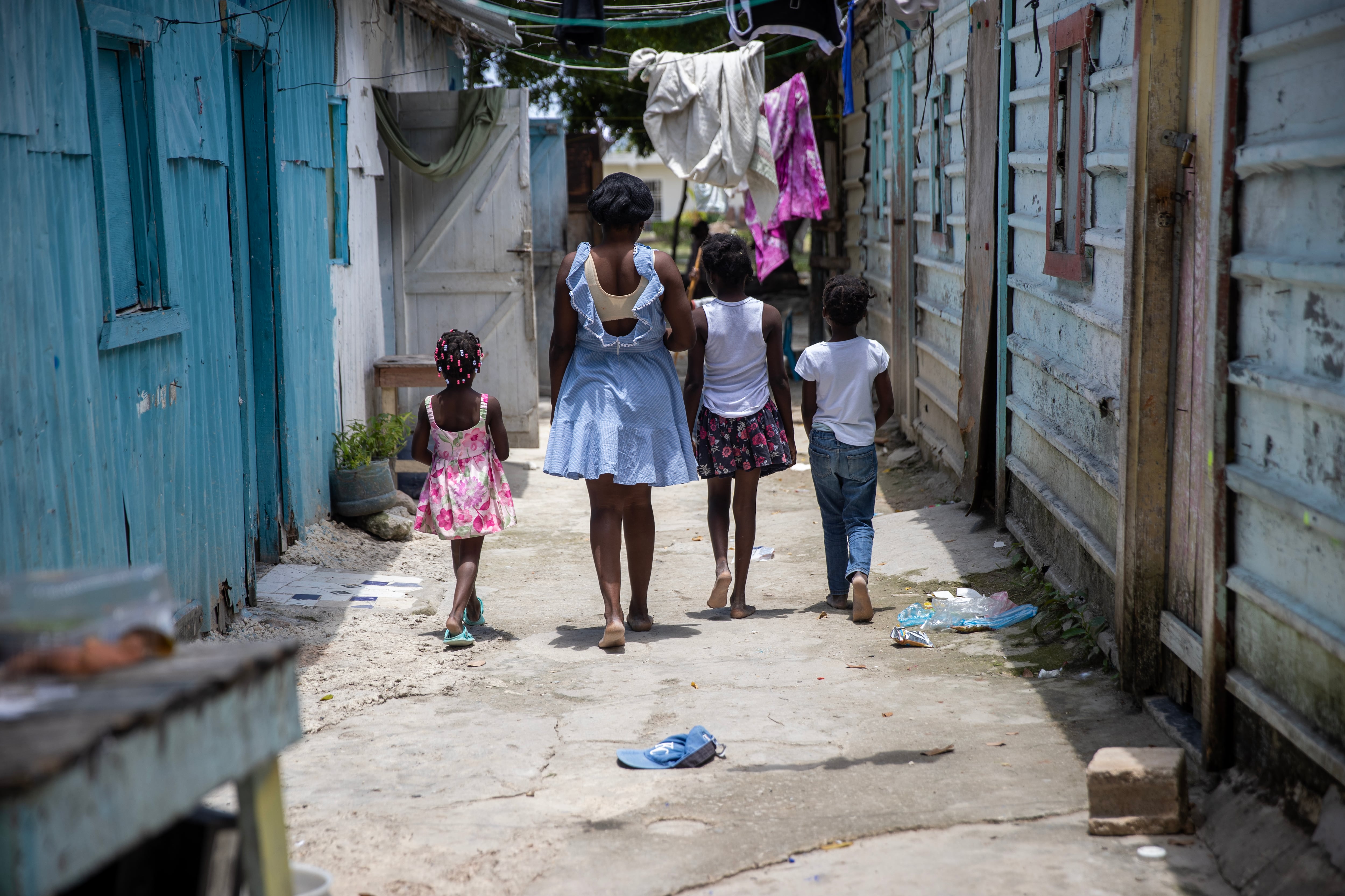 Abigail (center) walks with Haitian children who live in the community of Friusa, in Punta Cana, Dominican Republic.