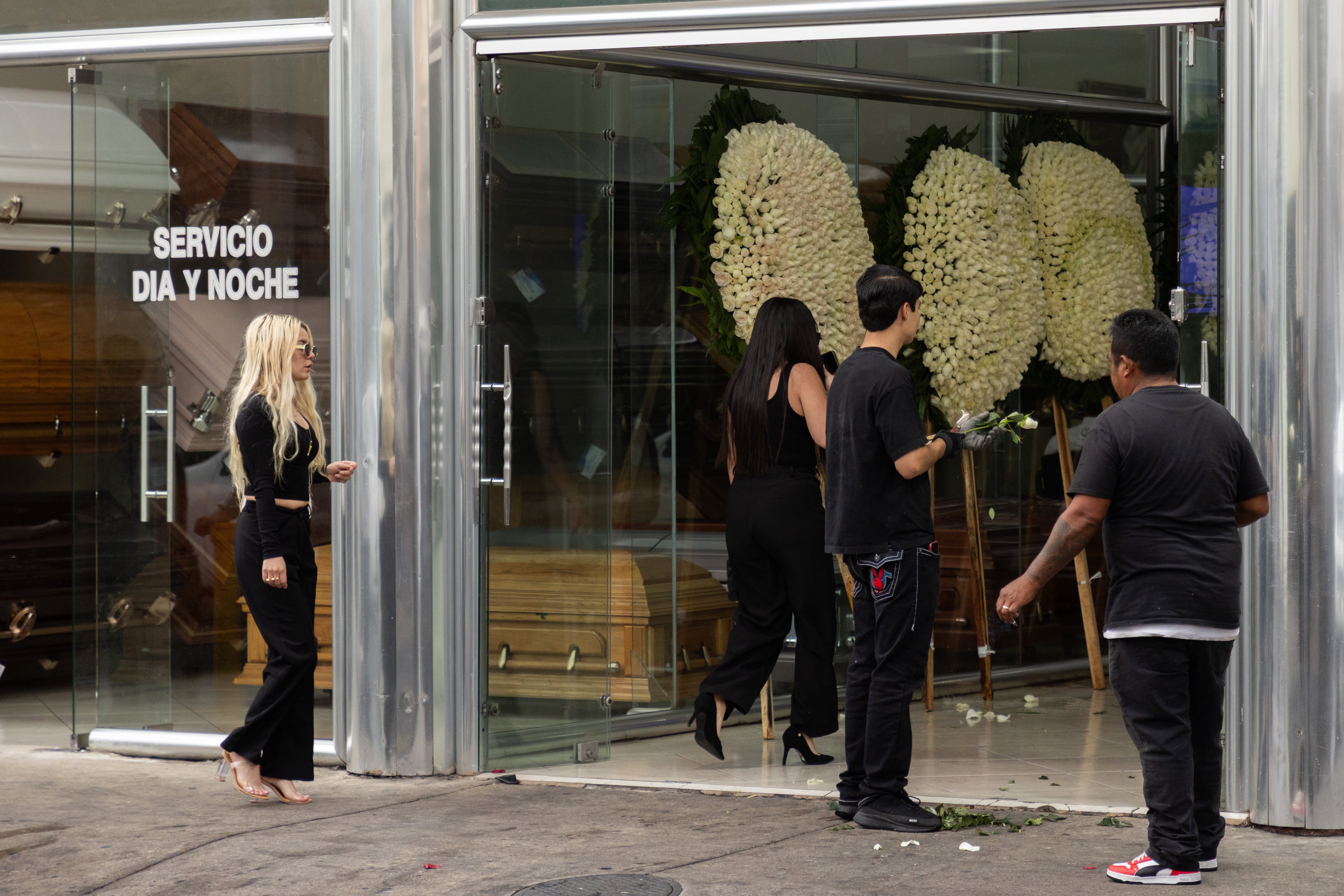 People leave the funeral home where Mencho's remains were located.