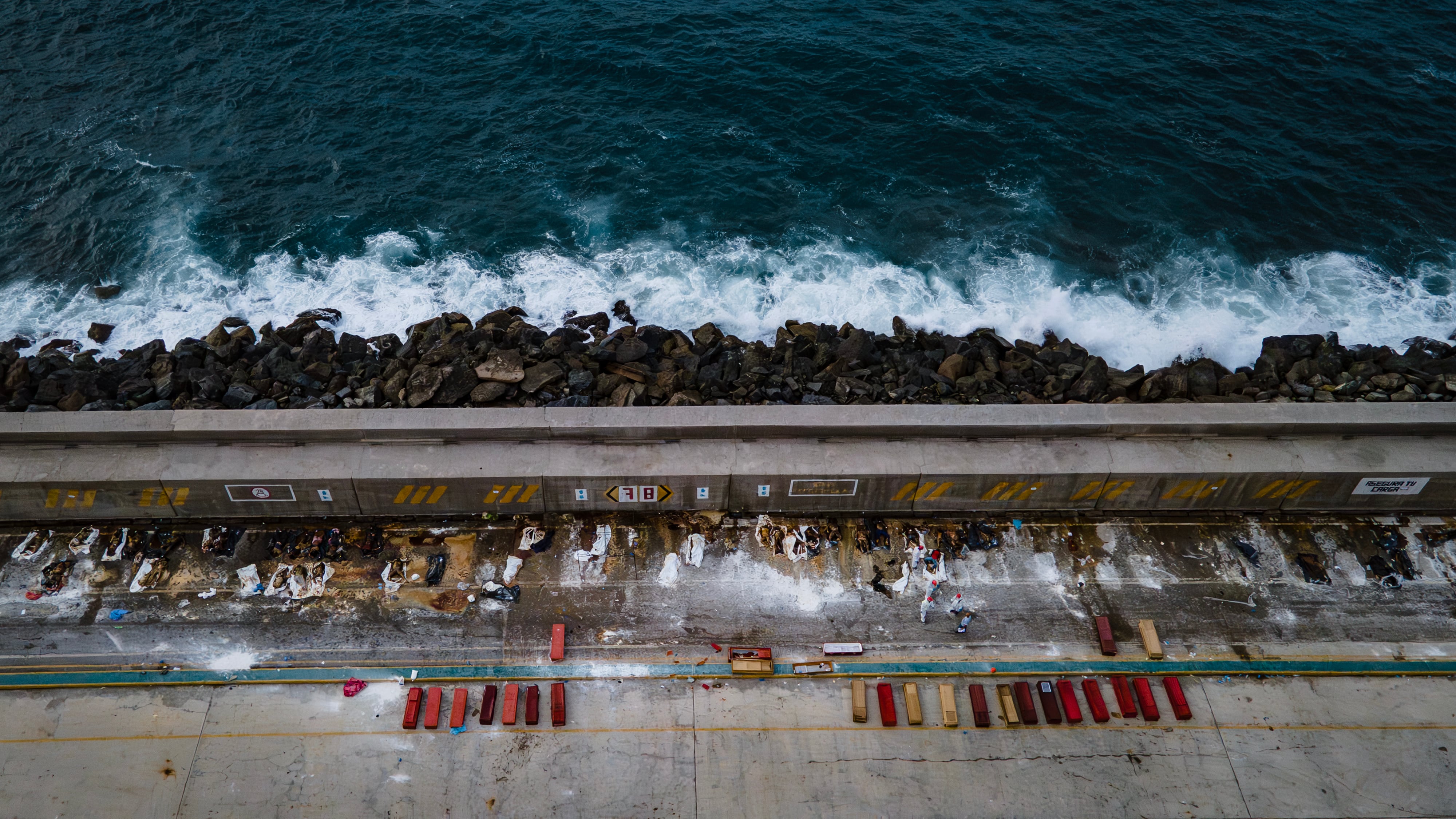 Bodies of earthquake victims are placed at La Guaira port in Venezuela, June 30.