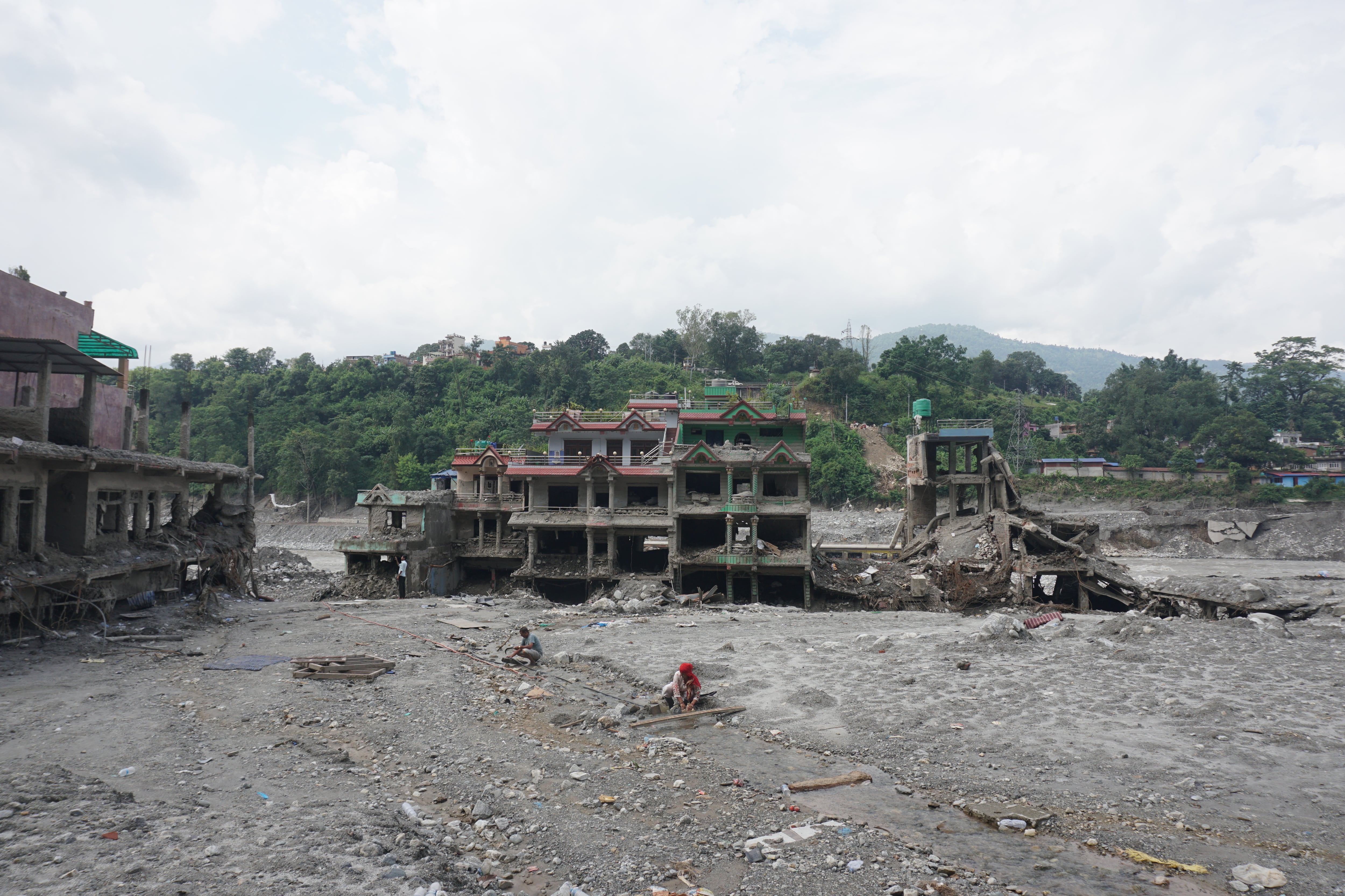 Residents collect water after floods in Nuwakot, Nepal, on September 17, 2026.