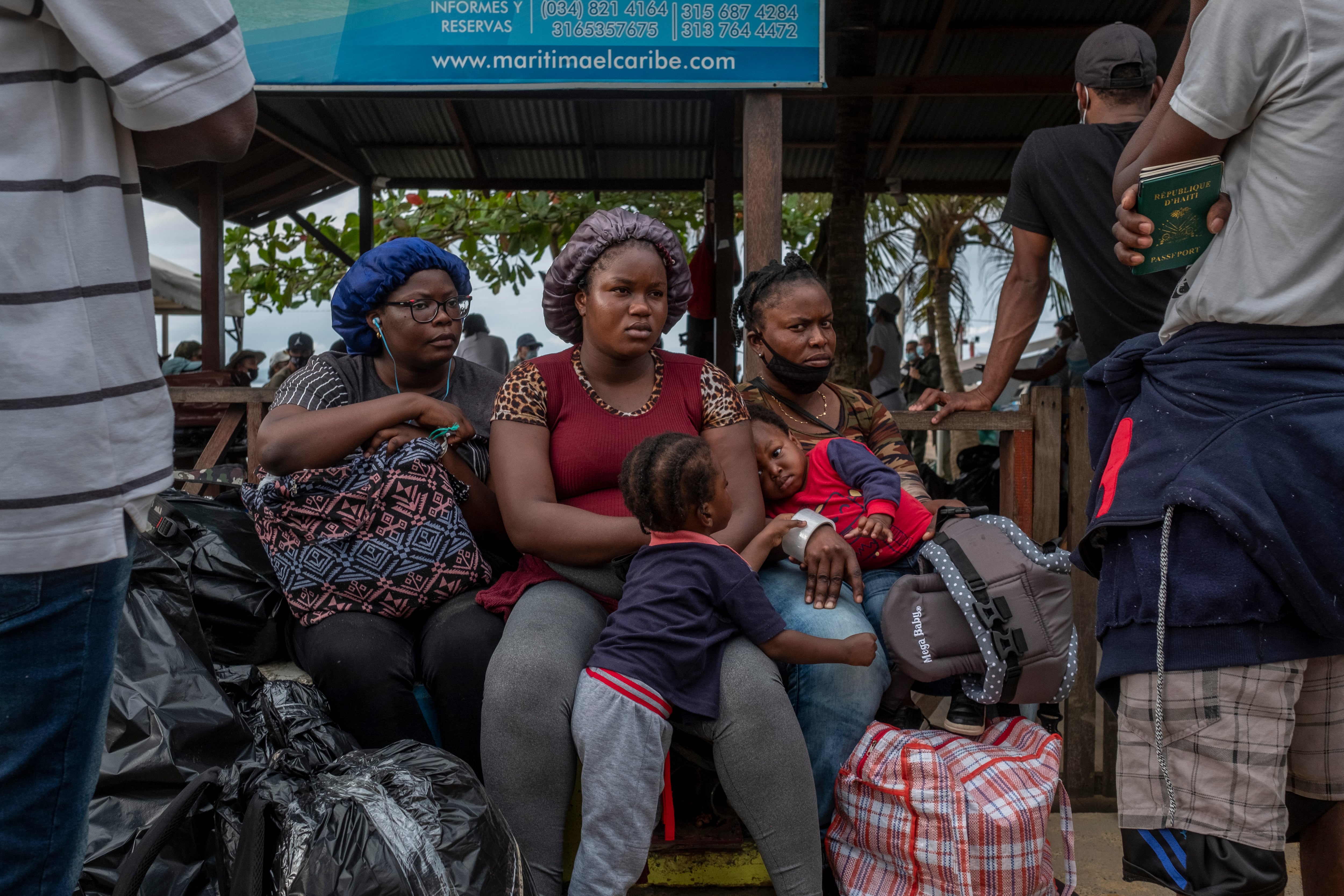A group of Haitian migrant women and their children wait to board a boat from Necocli, Colombia to Capurgana, and then cross the Darién Gap to Panama; August 5, 2021.