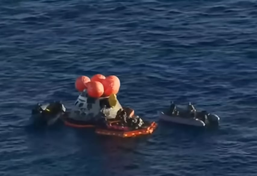 The Artemis 2 capsule, with its upper floats and front porch deployed, floats in the Pacific Ocean on April 10.