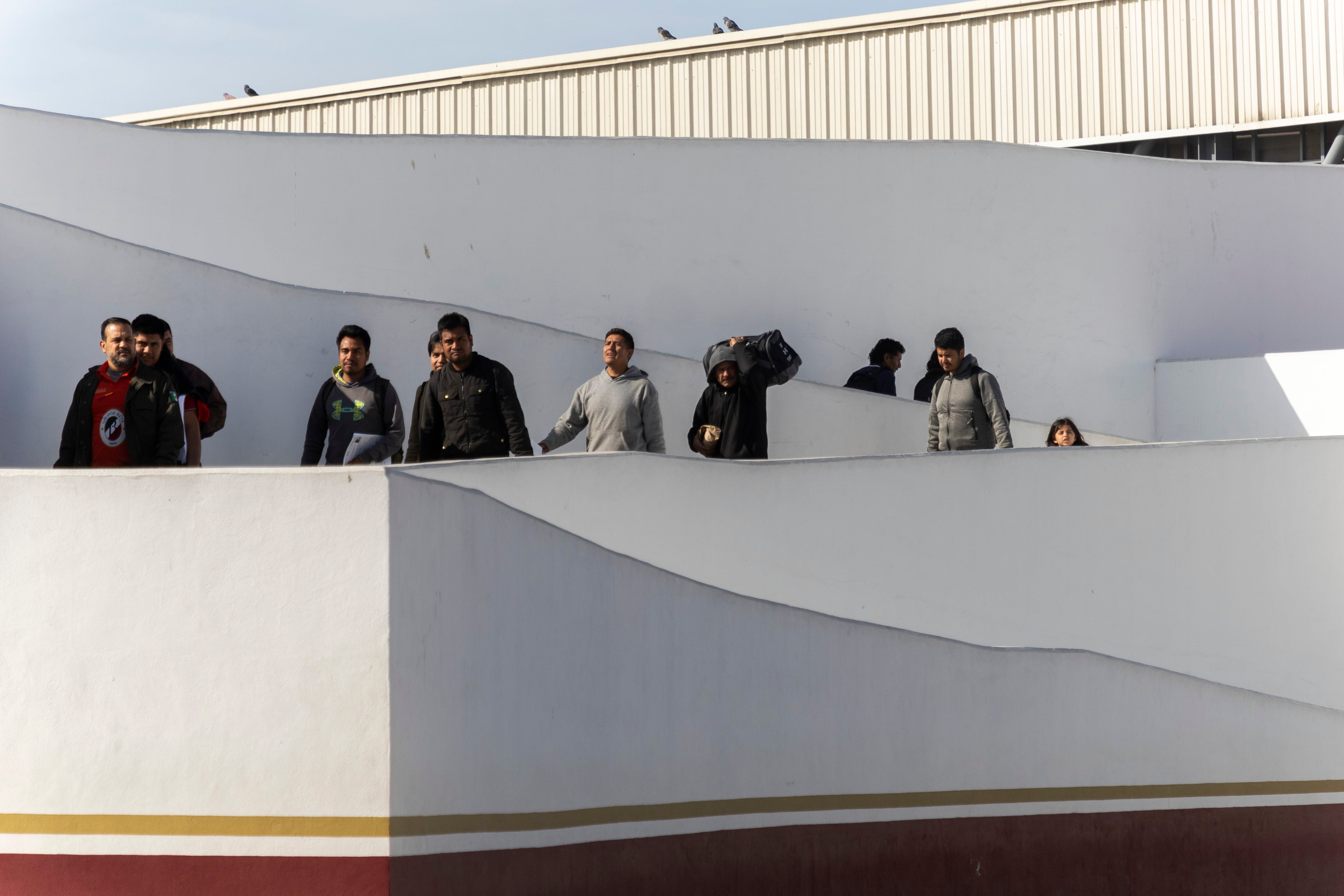 Deported people leave the El Chaparral checkpoint.