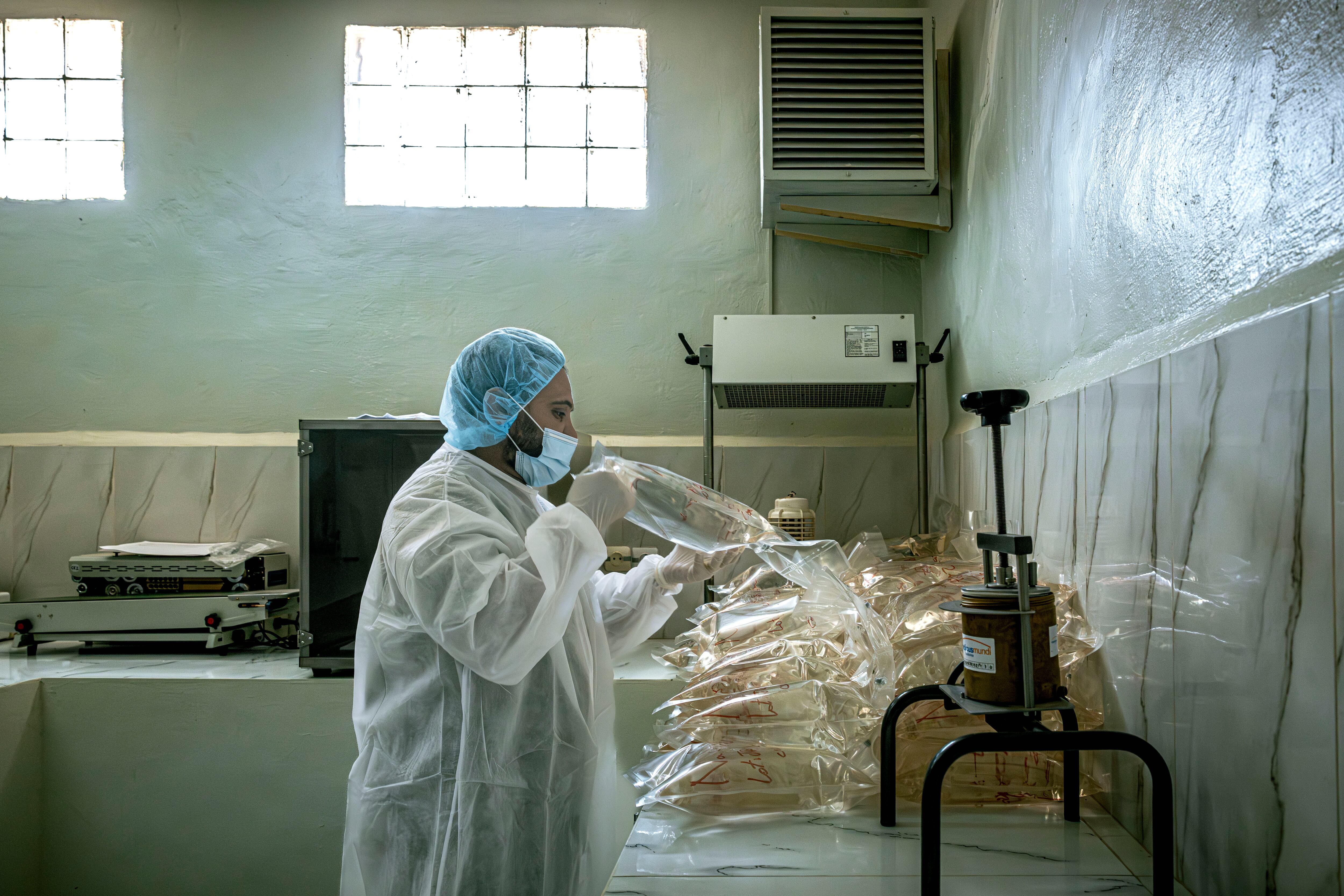 In this image, lab technician Brahim Saleh Labeid handles IV bags intended for treatments in the Urology Department, on April 29, 2026. 