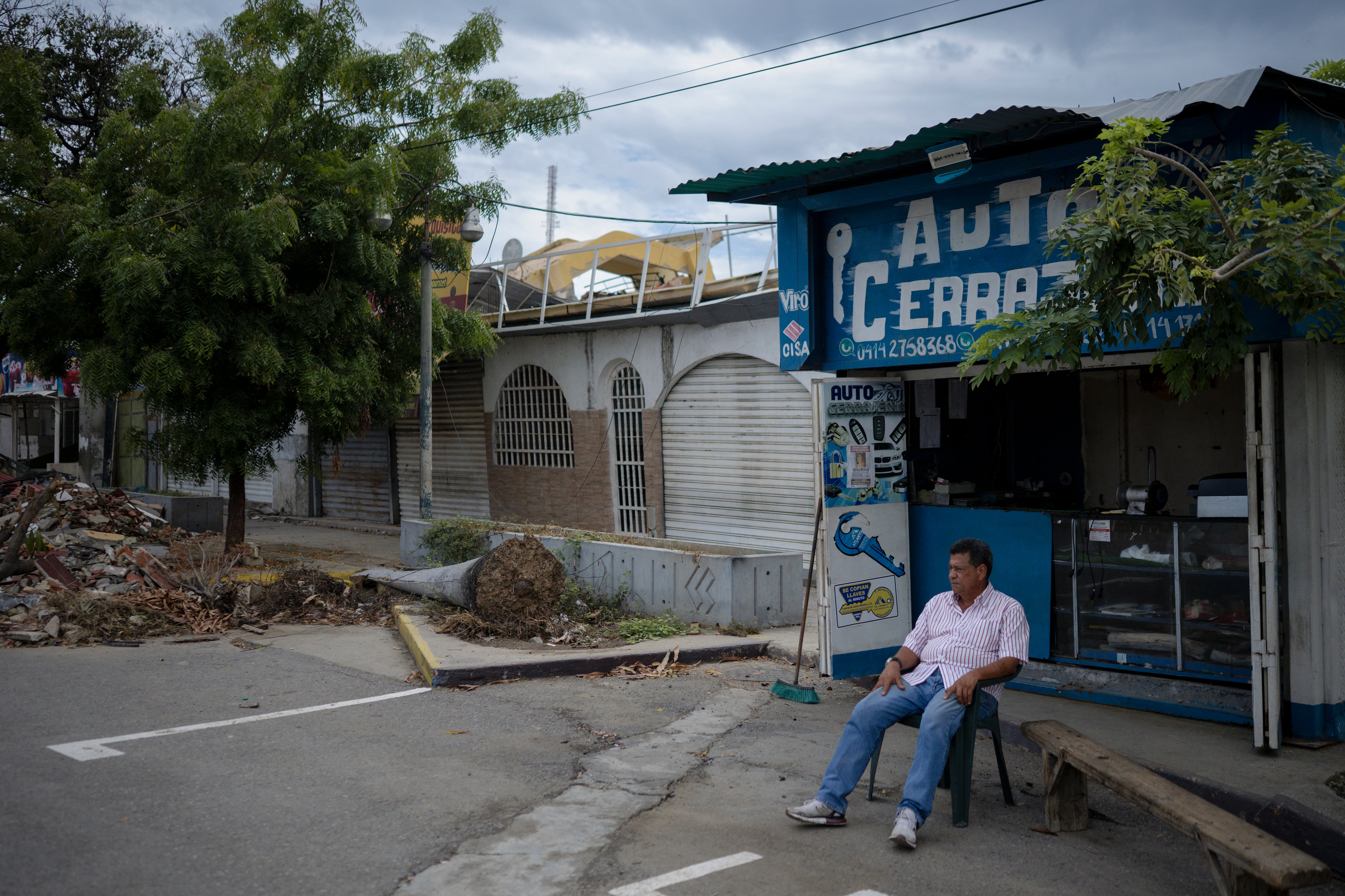 Hover Cardona, owner of an auto-locksmith, in front of his business.