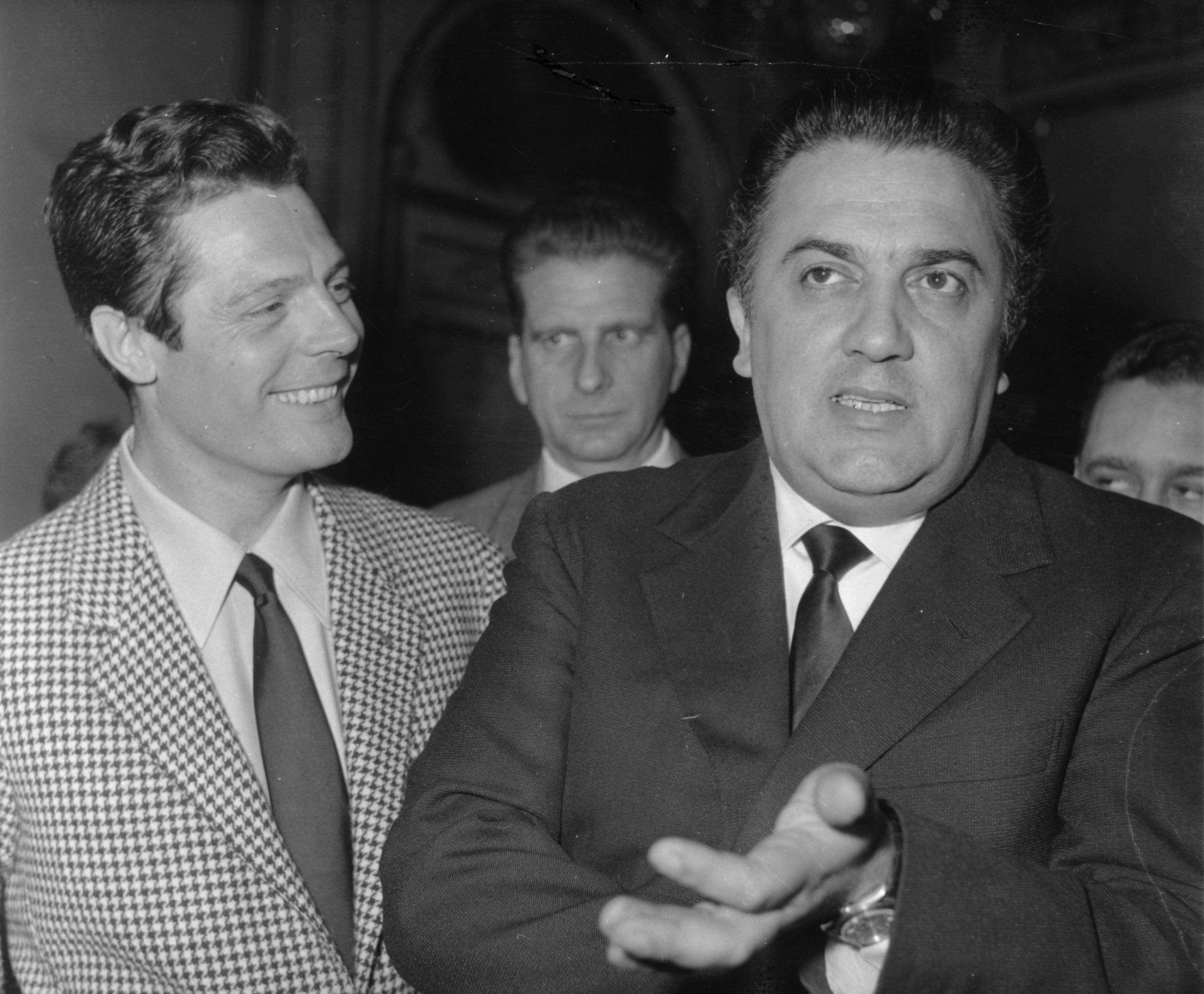Federico Fellini and Marcello Mastroianni, during a press conference on the promotional tour for 'La Dolce Vita' (1960).