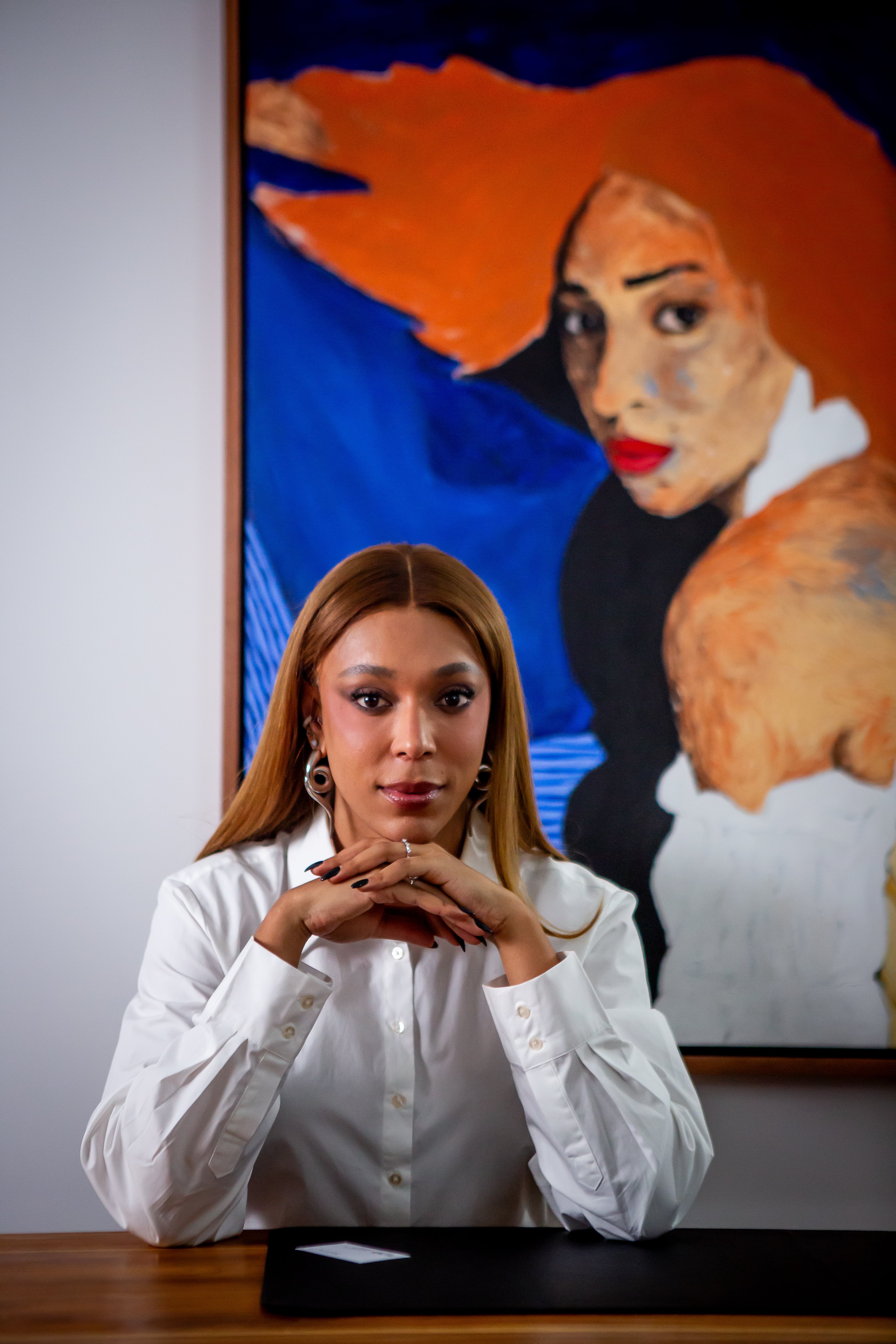 Hilton next to a painting in her office.