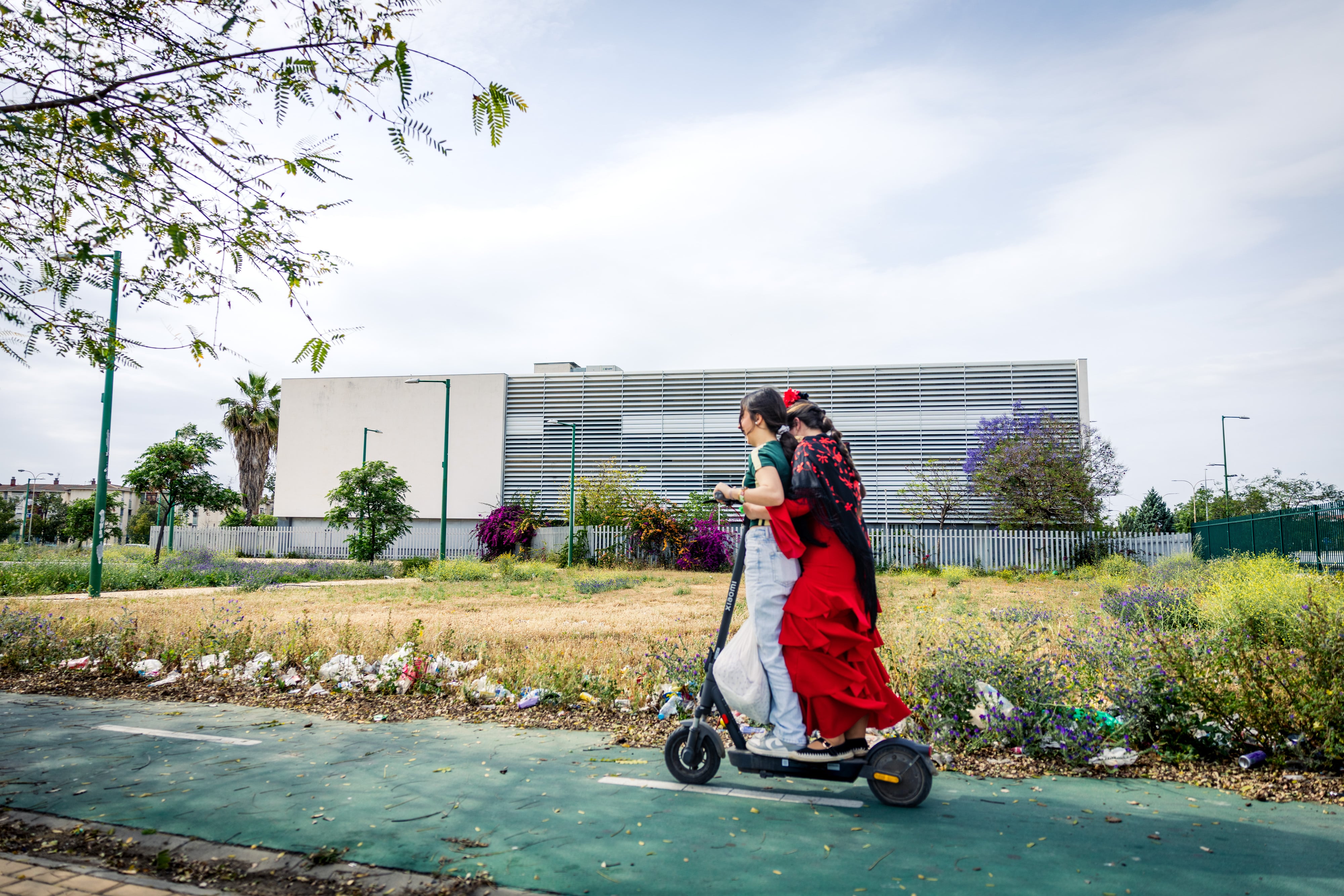 Two young people travel on a scooter in the Las 3.000 Viviendas neighborhood of Seville, on April 23.