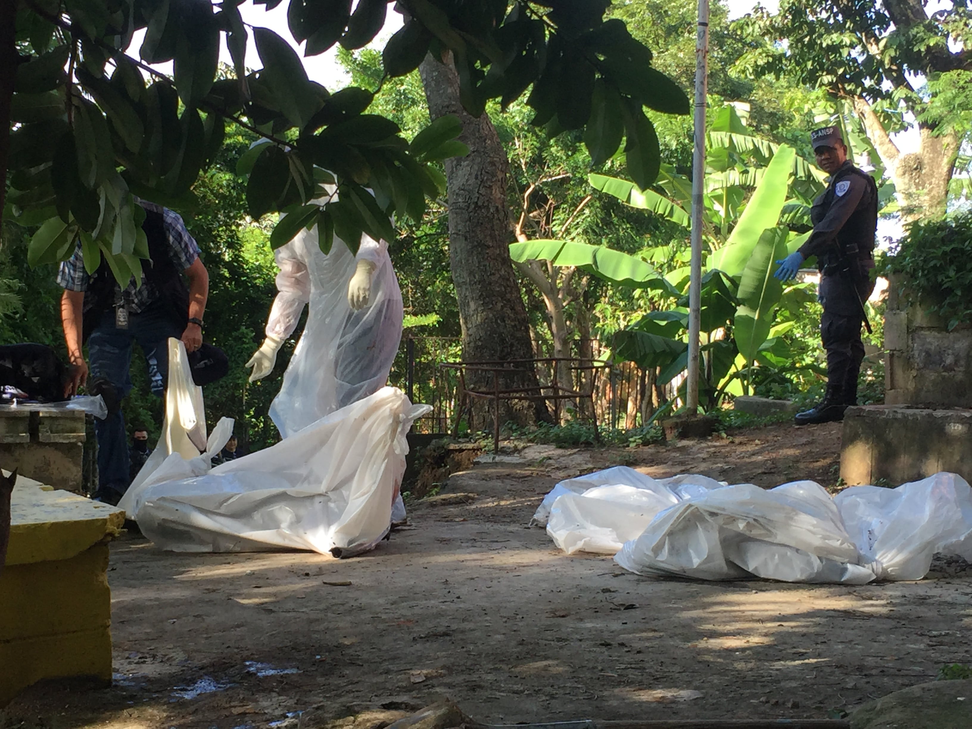 Forensic teams collect bodies removed from a clandestine cemetery in the Santísima Trinidad neighborhood, in San Salvador, in August 2020.