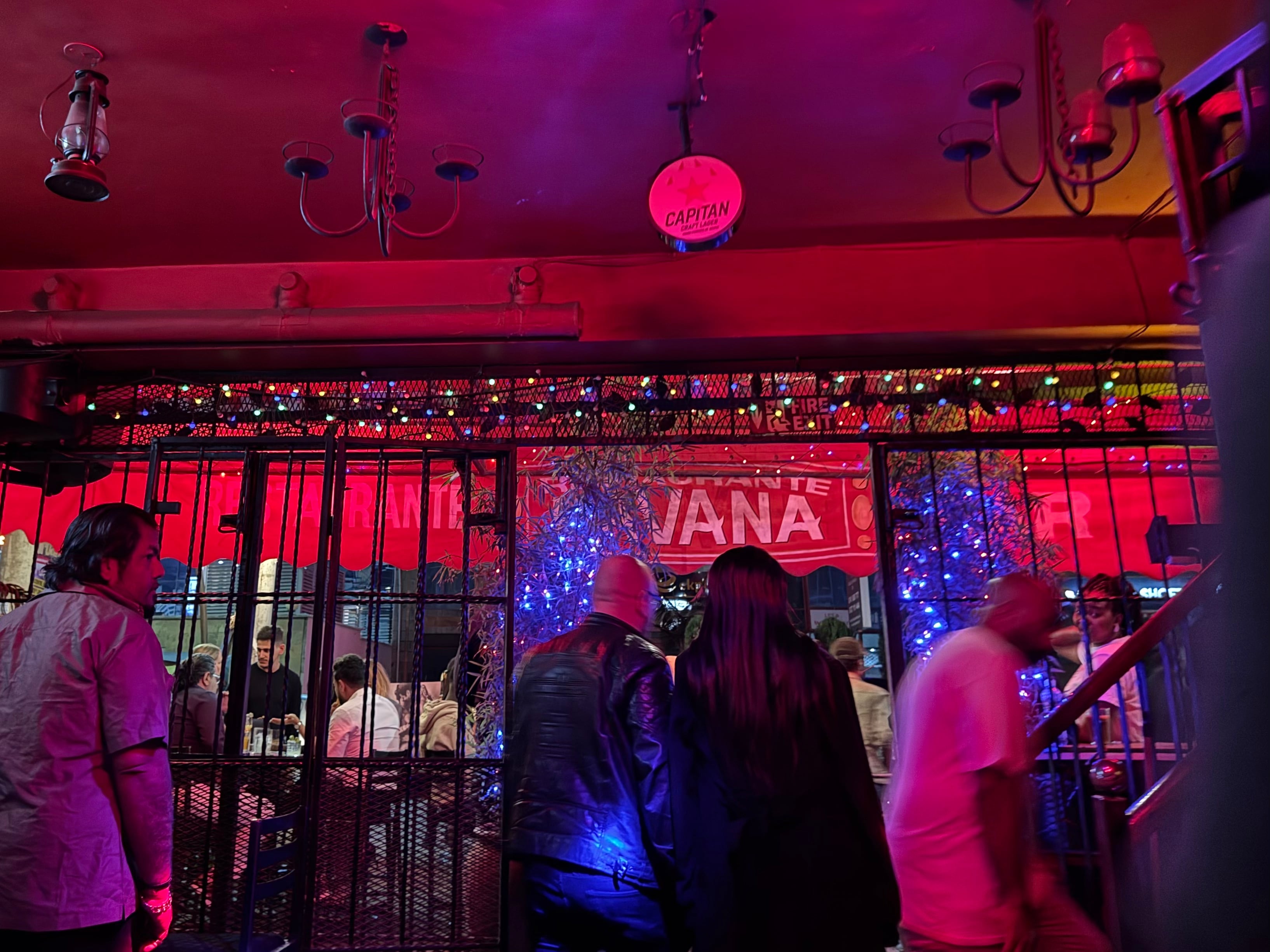 A European man and a young Kenyan woman leave a Nairobi bar together on December 28, 2024.