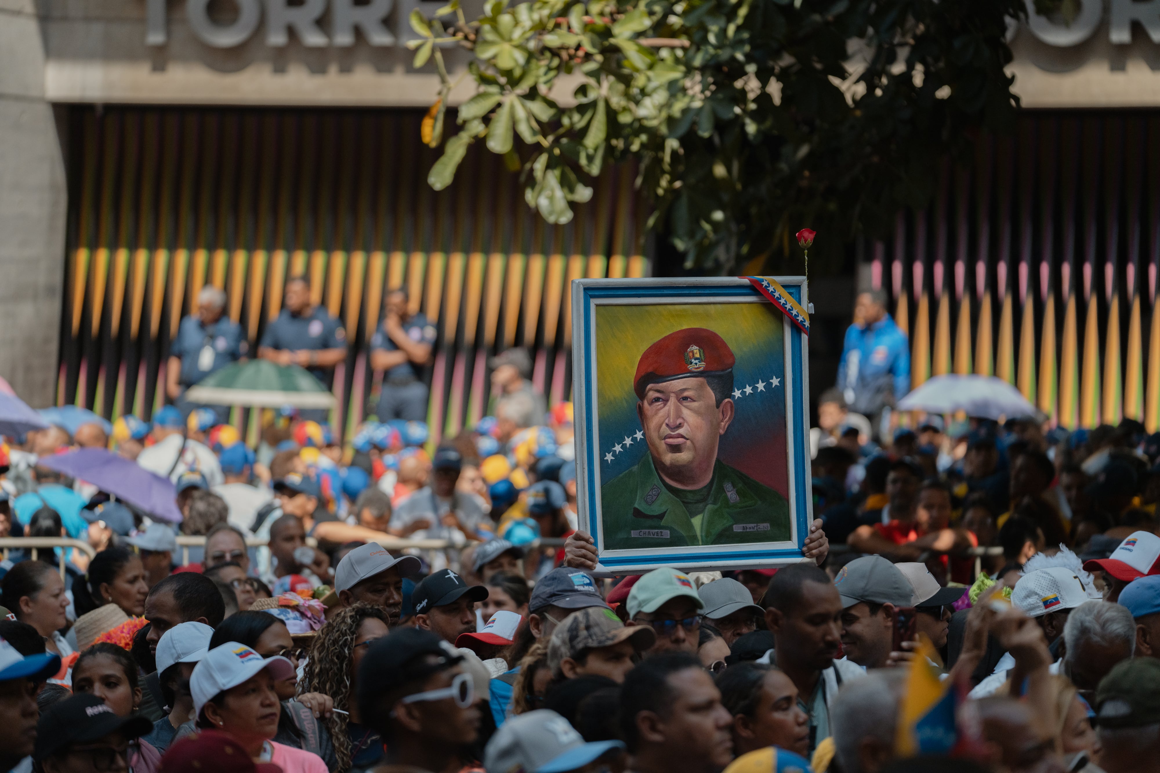 A woman holds a sign of Hugo Chávez at a march organized by Chavismo in Caracas, on April 9.