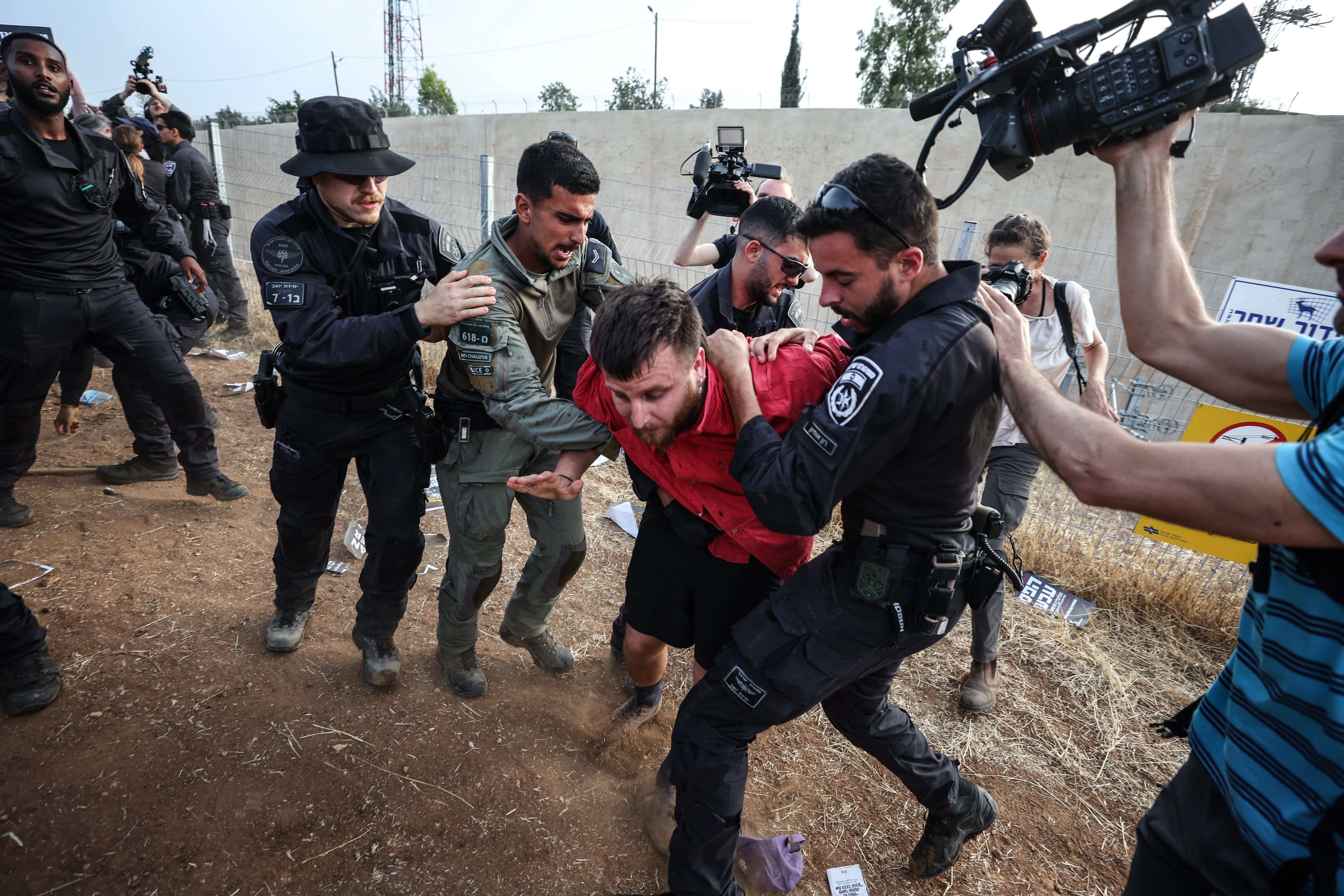 Israeli police officers restrain a protester during Sunday's protest against the Israeli offensive in Gaza in Sderot.