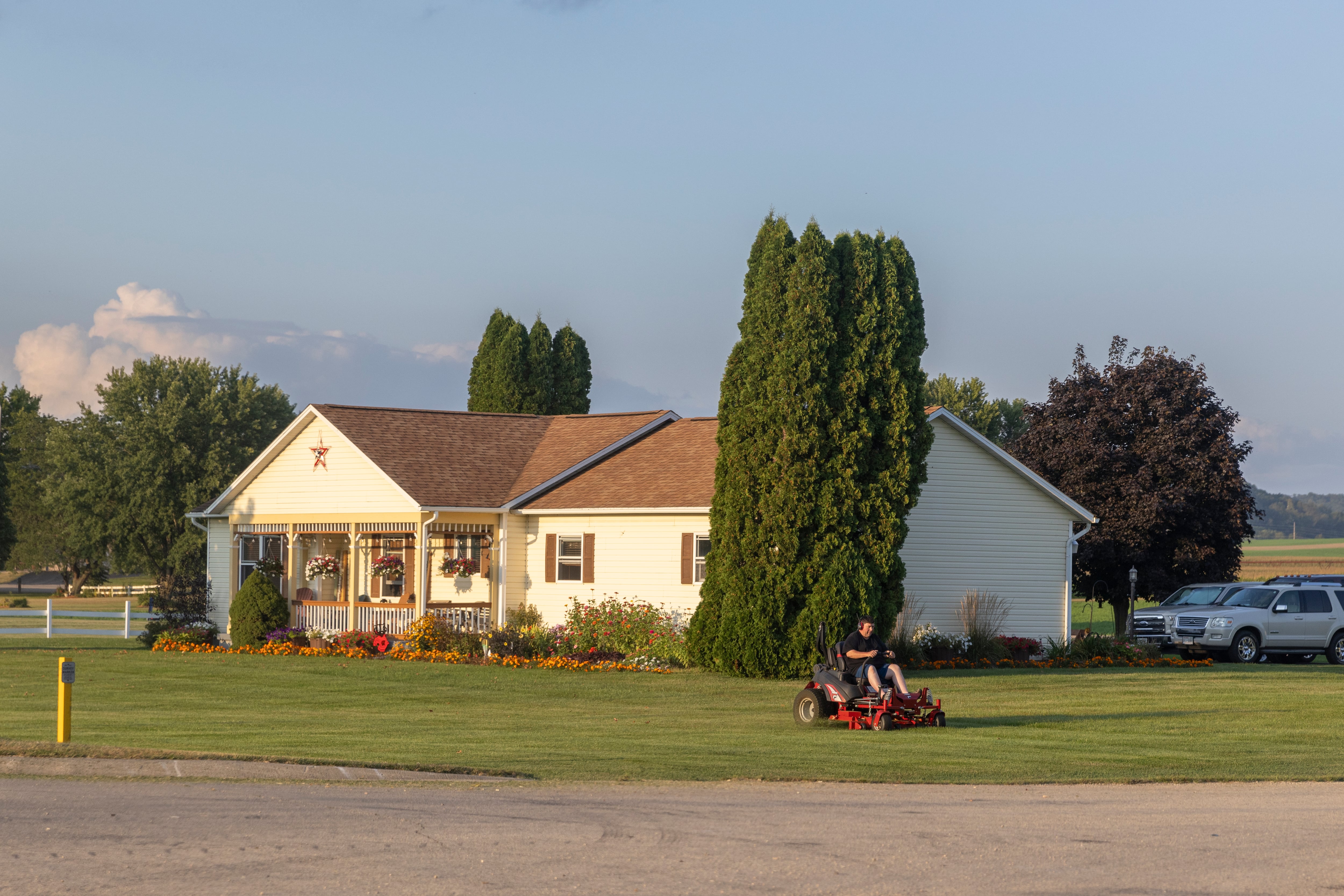 A man mows the lawn of his home on the highway between Milwaukee and Richland Center in the swing state of Wisconsin.