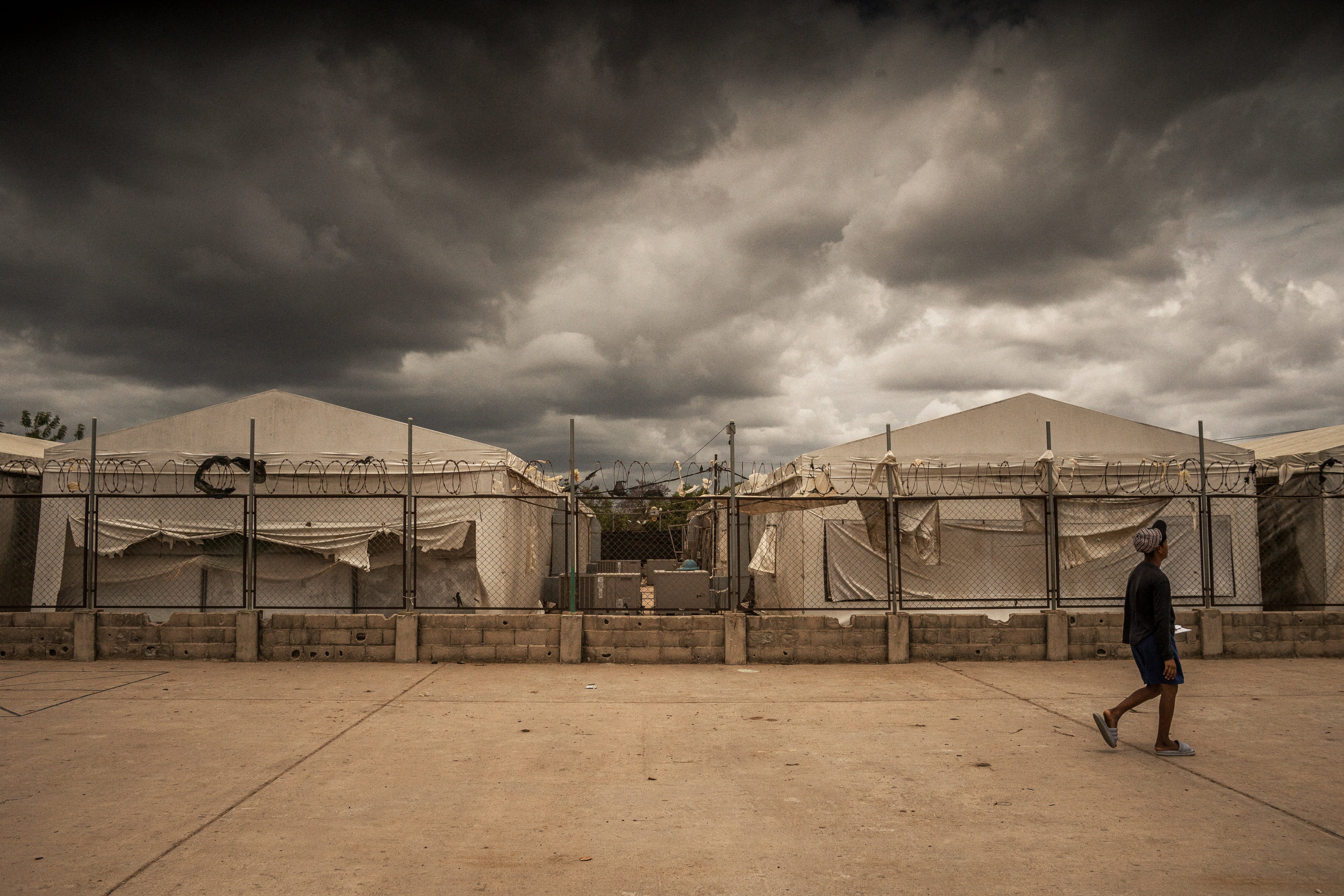 A young man walks in front of what used to be a humanitarian camp in La Pista, La Guajira, Colombia, on April 22, 2025.