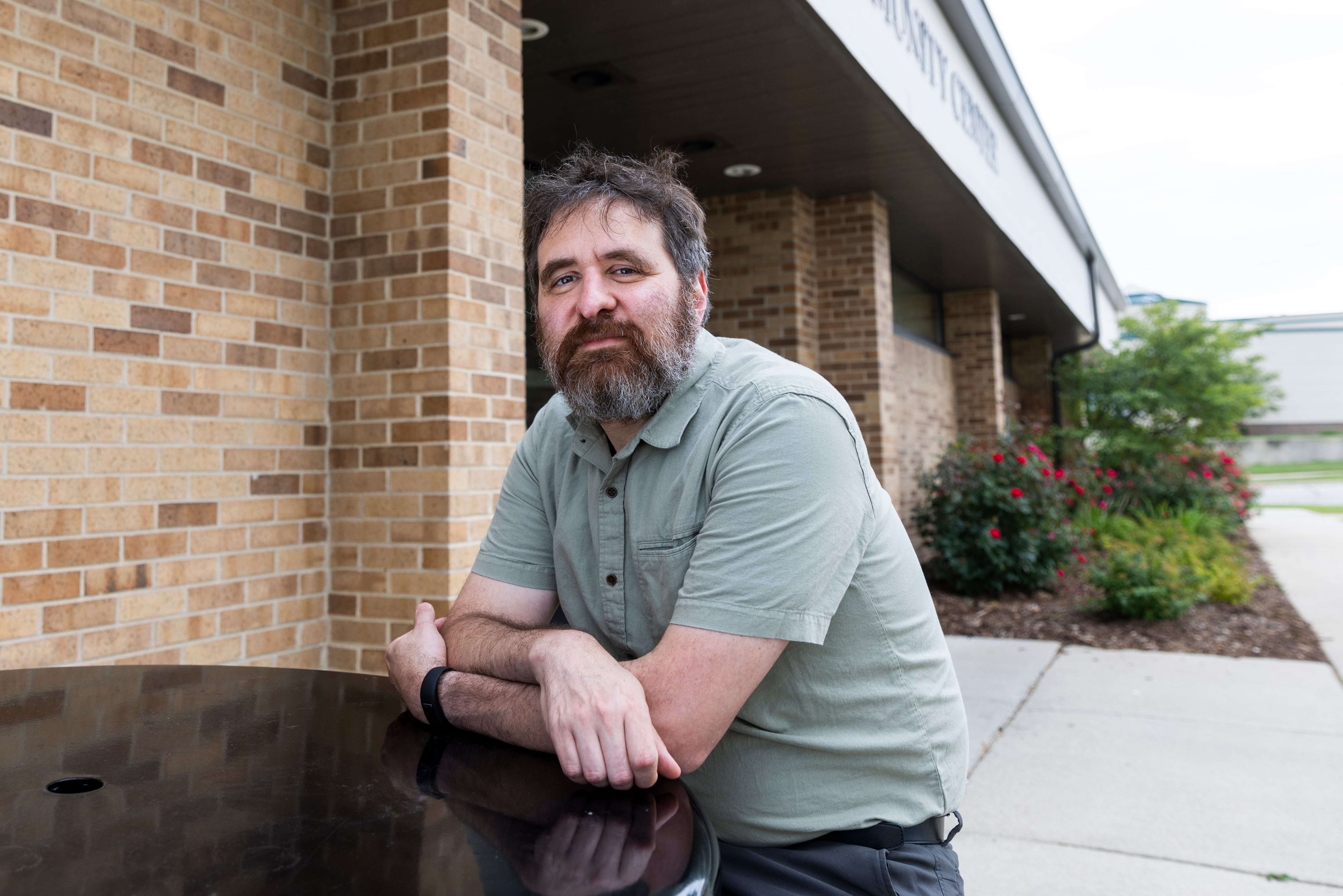 Michael Mirer, a professor at the University of Milwaukee, stands outside the suburban polling station where he will volunteer for the November ballot.