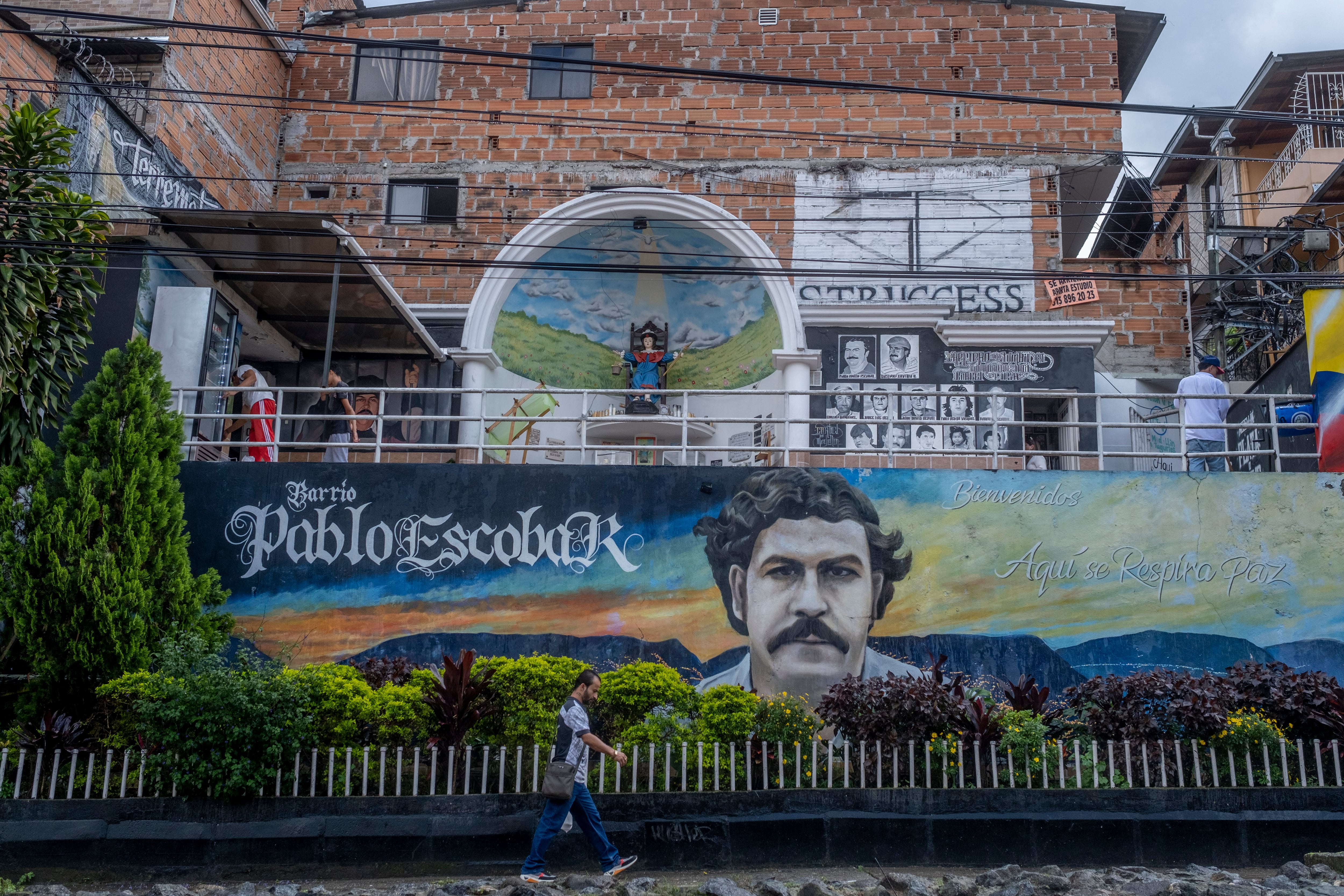 Tourists walk the streets of the Pablo Escobar neighborhood in Medellín, in 2023.