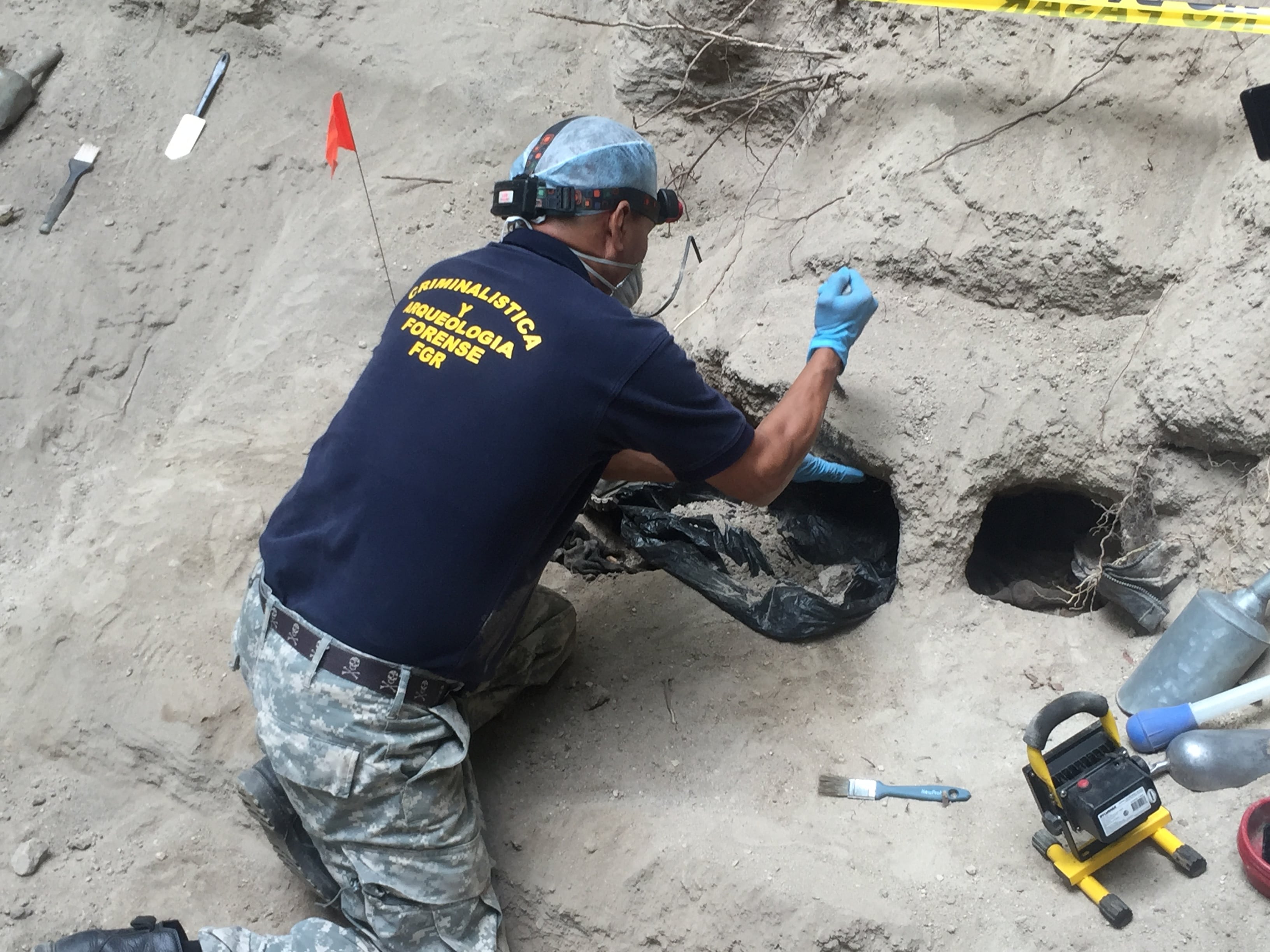 Israel Ticas excavates at a clandestine cemetery in Ilopango, El Salvador.