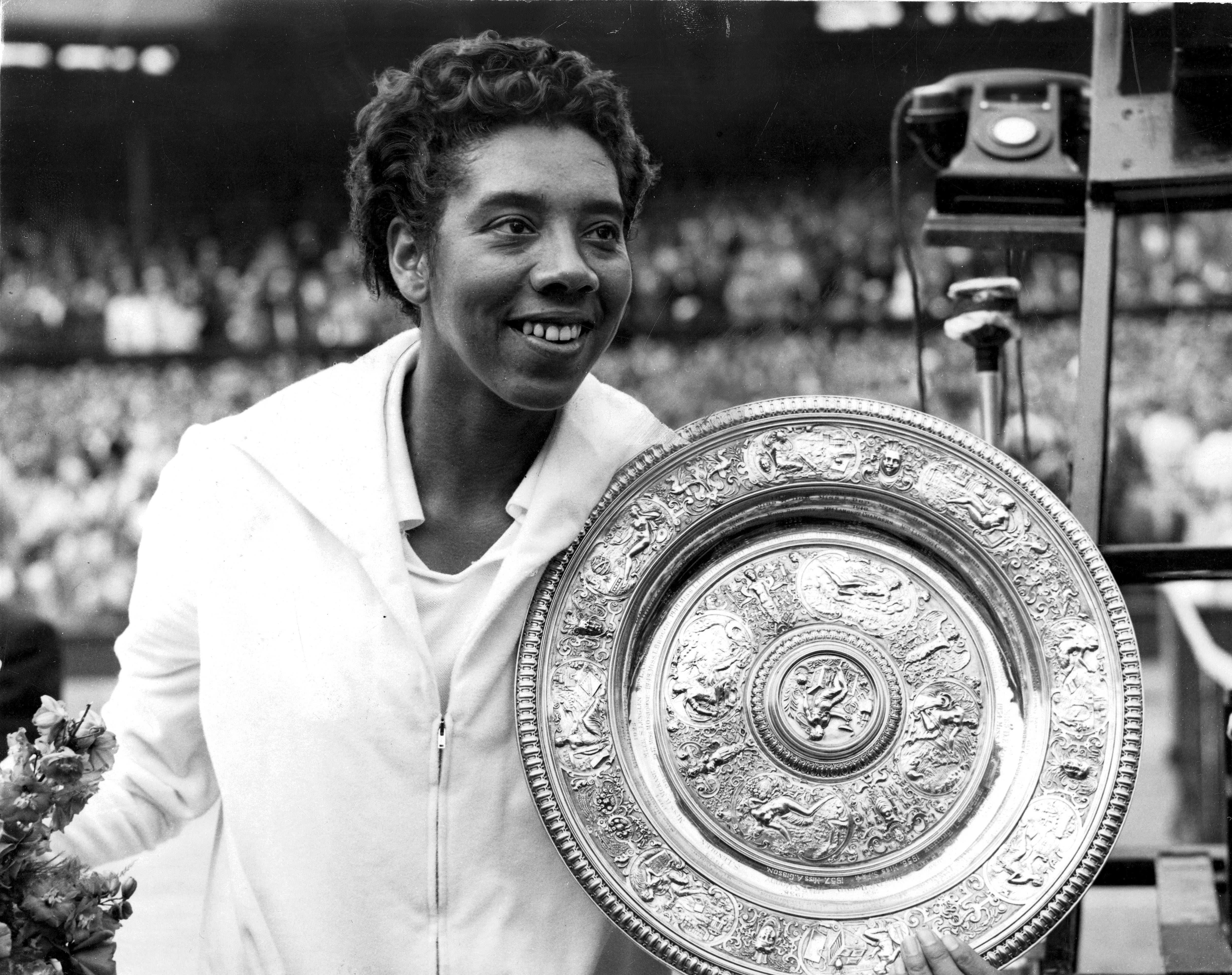Althea Gibson with her trophy at Wimbledon in 1958.