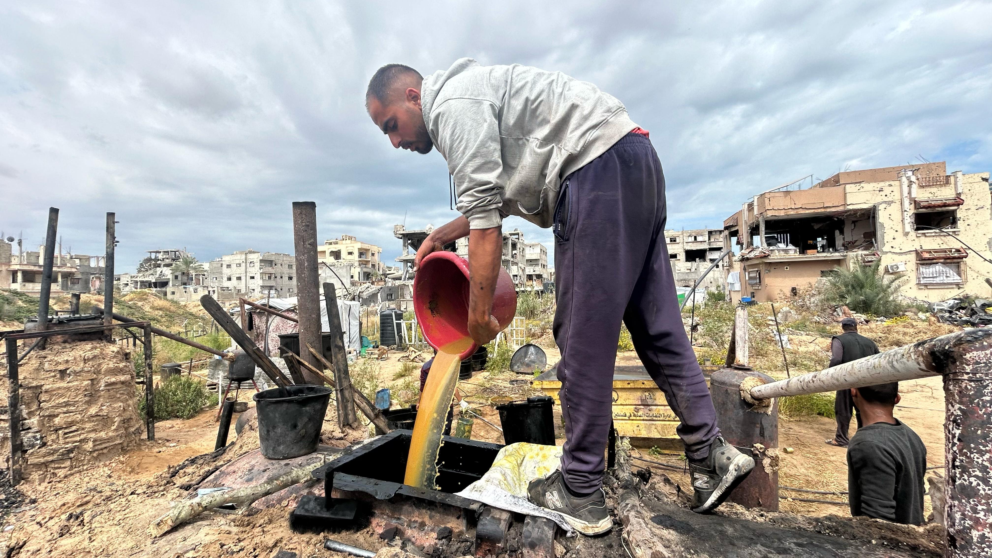 Abdel Rahman Asfour prepares homemade fuel in Khan Younis, Gaza.