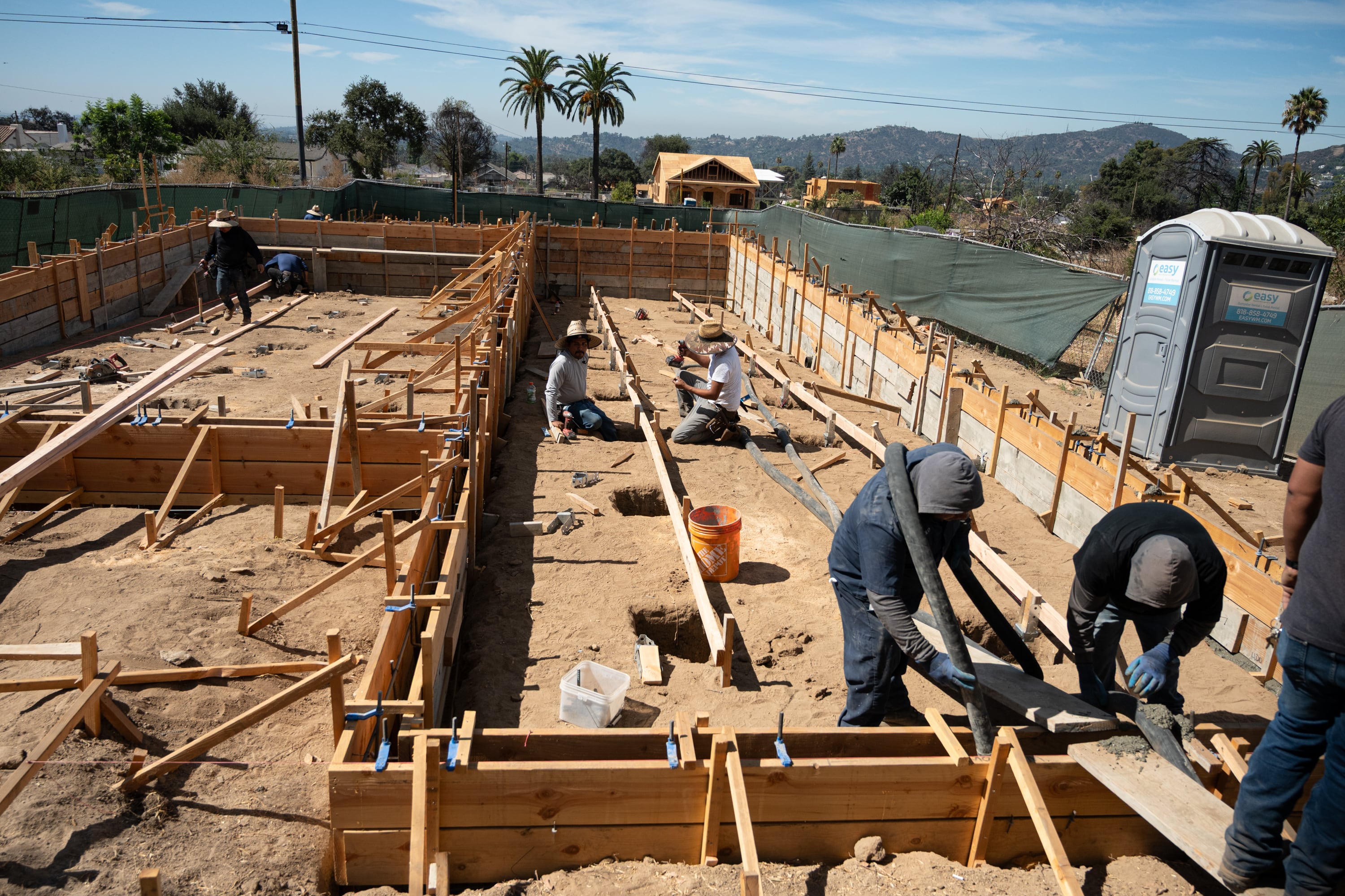 Workers rebuild a home in Altadena, California, last Tuesday.
