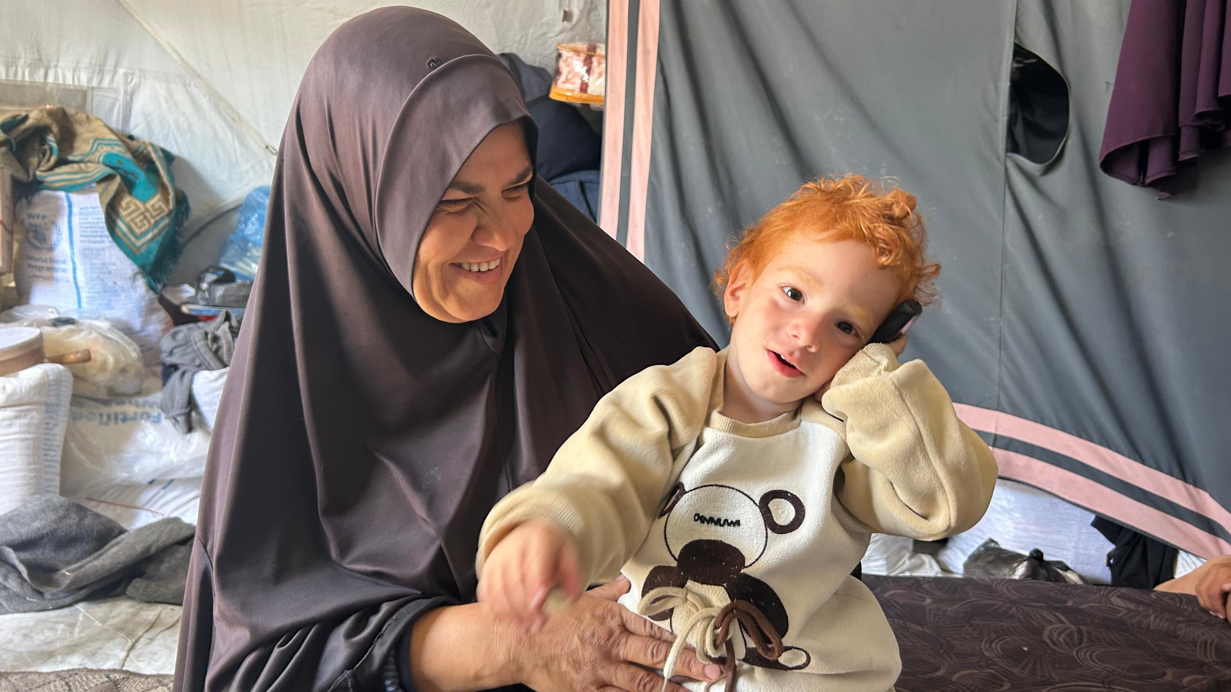 Ibrahim Badr in his grandmother's arms, in Gaza City, in April 2026.