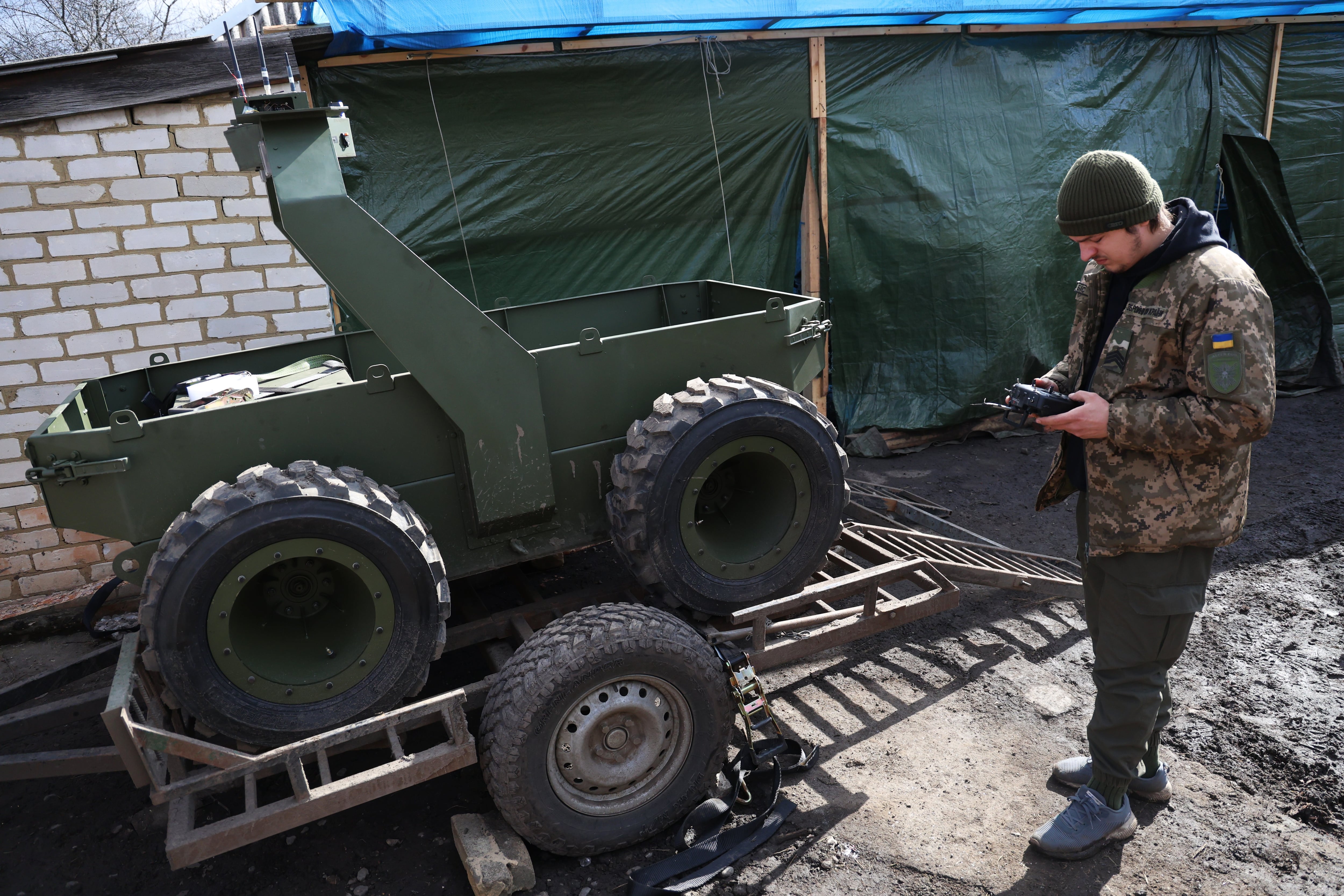 Ukrainian military personnel working at a workshop specializing in ground robots in the eastern Donetsk region.