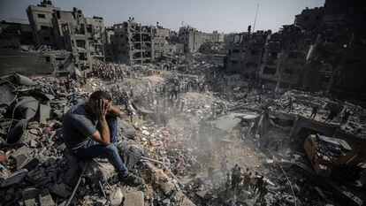 A man sits on rubble after the Israeli bombing of the Jabalia refugee camp in Gaza on November 1.
