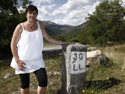 The mayor of Llivia, Silivia Orriols, by one of the stones that marks the limits of the village.