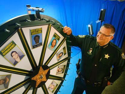 Brevard County Sheriff Wayne Ivey gets ready to spin his popular "Wheel of Fugitive" in July 2017, in Titusville, Fla.