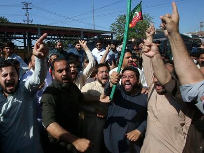 Supporters of Pakistan's former Prime Minister Imran Khan chant slogans as they block a road as a protest to condemn the arrest of their leader, in Peshawar, Pakistan, on May 9, 2023.