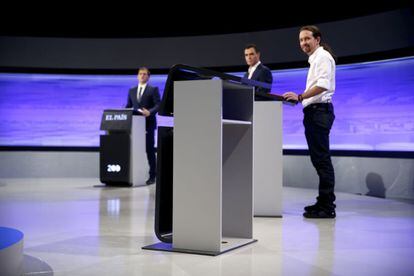 The candidates look at Rajoy&rsquo;s empty lectern during the debate.