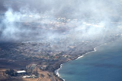 This handout photo courtesy of Carter Barto via Facebook shows an aerial view of smoke rising above as a wildfire burns in Lahaina, Hawaii, on August 9, 2023. 