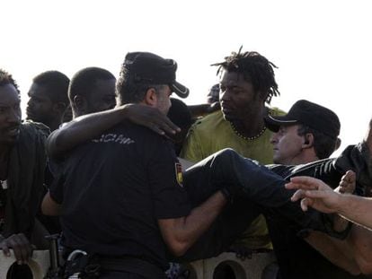 Police grappling with immigrants on Ceuta&#039;s beach after a mass attempt to swim onto Spanish soil. 