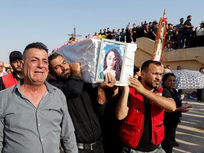Mourners carry a coffin of a victim of the fatal fire of a wedding celebration, during the funeral in Hamdaniya, Iraq, on September 27, 2023.