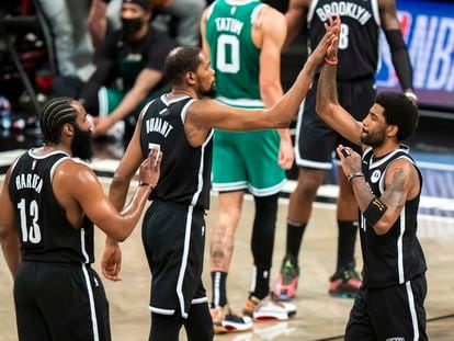 Brooklyn Nets guard James Harden (13), forward Kevin Durant (7) and guard Kyrie Irving celebrate during the first half of Game 1 of an NBA basketball first-round playoff series Saturday, May 22, 2021, in New York.
