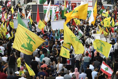 Supporters of Hezbollah wave Palestinian, Lebanese and Hezbollah flags during a protest in solidarity with Palestinians, in Beirut (Lebanon), on October 27, 2023.