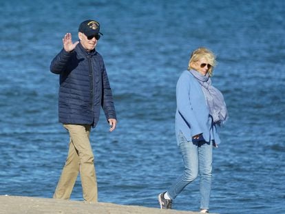 U.S. President Joe Biden waves as he and first lady Jill Biden walk along the shore at Rehoboth Beach, Delaware, U.S., October 22, 2023.