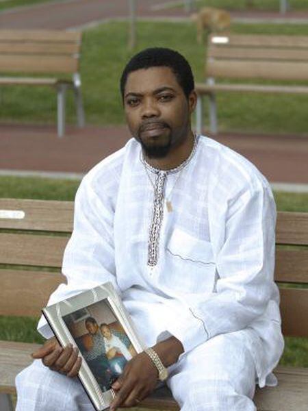 Kelly Agbons poses with a photo of his son, Osagi.