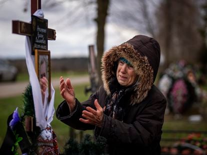 Valentyna Nechyporenko mourns at the grave of her 47-year-old son Ruslan, during his funeral at the cemetery in Bucha, on the outskirts of Kyiv, April 18, 2022.