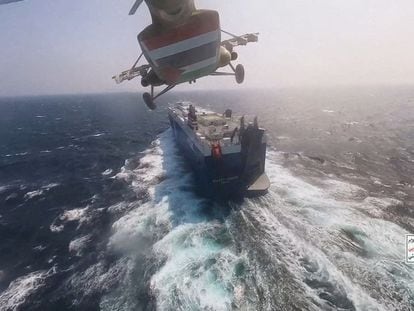 Houthi military helicopter flies over the Galaxy Leader cargo ship in the Red Sea in this photo released November 20, 2023.