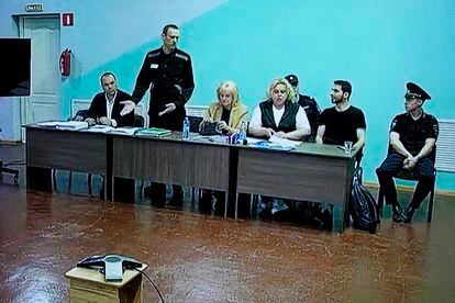 Opposition leader Alexei Navalny, 2nd left, stands between his lawyers in a courtroom, during a preliminary hearing, in Melekhovo, Vladimir region, Russia.