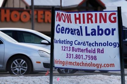 File - A hiring sign is seen in Downers Grove, Ill., Thursday, May 5, 2022. On Thursday, the Labor Department reports on the number of people who applied for unemployment benefits last week.