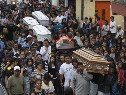 A funeral for five of the victims of the mudslide.